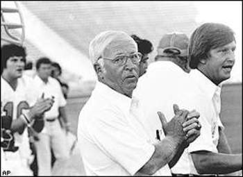 Circa 1970's : Head Coach John McKay of the Tampa Bay Buccaneers speaks to  the 49ers fans as O. J. Simpson of the San Francisco 49ers stands to  McKay's left hand side