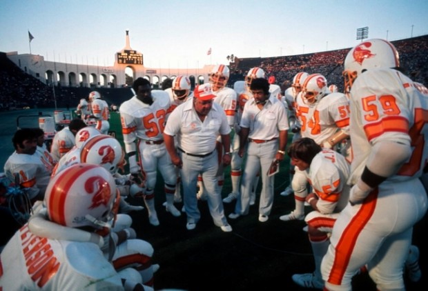 Circa 1970's : Head Coach John McKay of the Tampa Bay Buccaneers speaks to  the 49ers fans as O. J. Simpson of the San Francisco 49ers stands to  McKay's left hand side