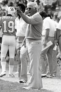 Circa 1970's : Head Coach John McKay of the Tampa Bay Buccaneers speaks to  the 49ers fans as O. J. Simpson of the San Francisco 49ers stands to  McKay's left hand side