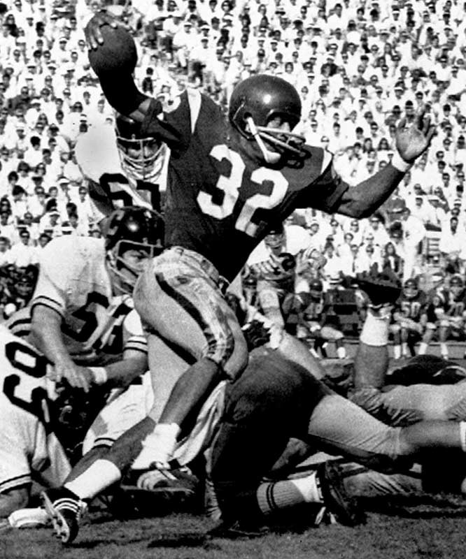 Circa 1970's : Head Coach John McKay of the Tampa Bay Buccaneers speaks to  the 49ers fans as O. J. Simpson of the San Francisco 49ers stands to  McKay's left hand side