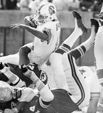 Circa 1970's : Head Coach John McKay of the Tampa Bay Buccaneers speaks to  the 49ers fans as O. J. Simpson of the San Francisco 49ers stands to  McKay's left hand side