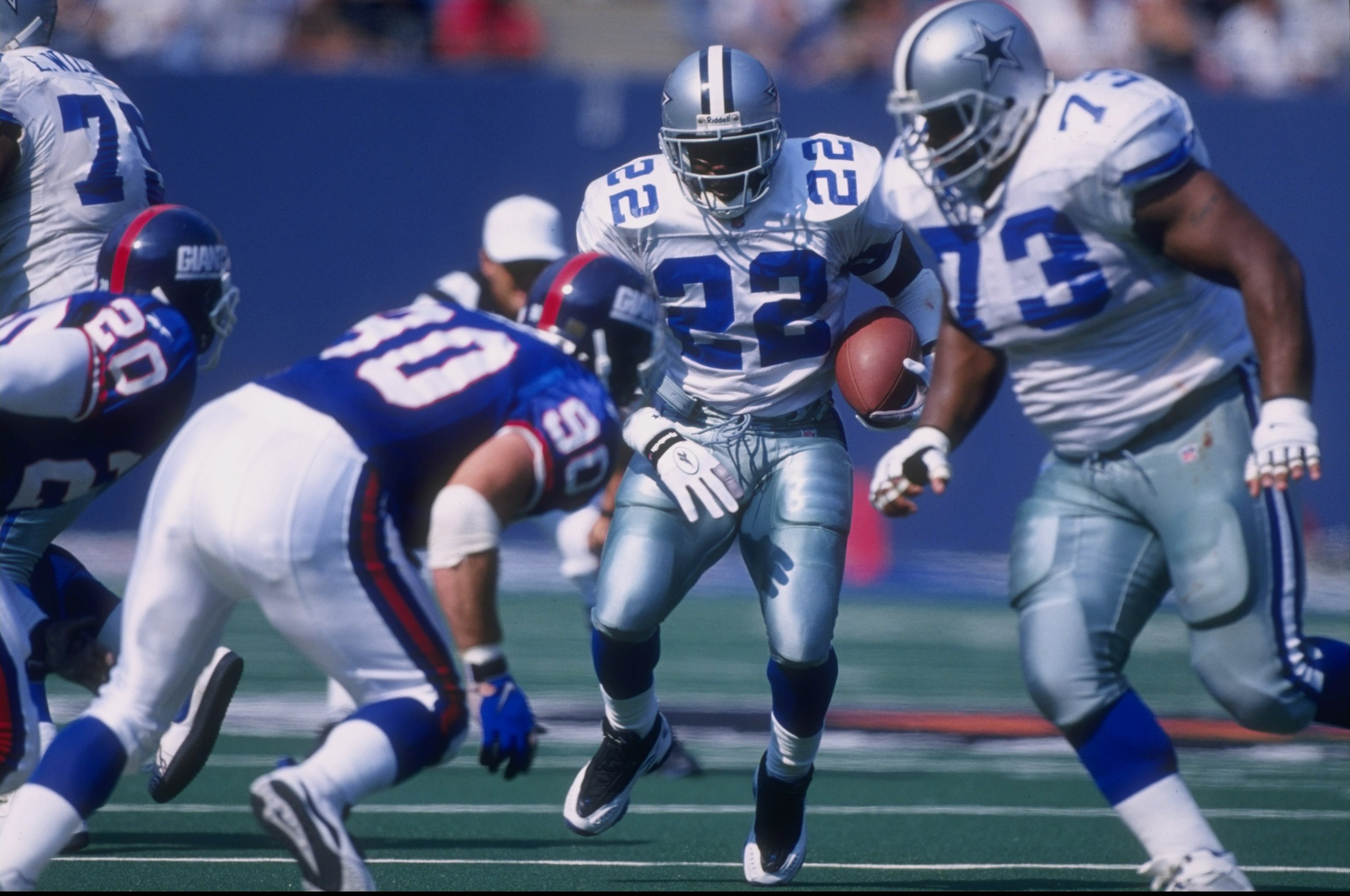 4 Oct 1997:  Emmitt Smith #22 of the Dallas Cowboys runs with the ball  as teammate Larry Allen #73 sets up to block Corey Widmer #90 of the New York Giants during a game at the Meadowlands in East Rutherford, New Jersey. The Giants defeated the Cowboys 2