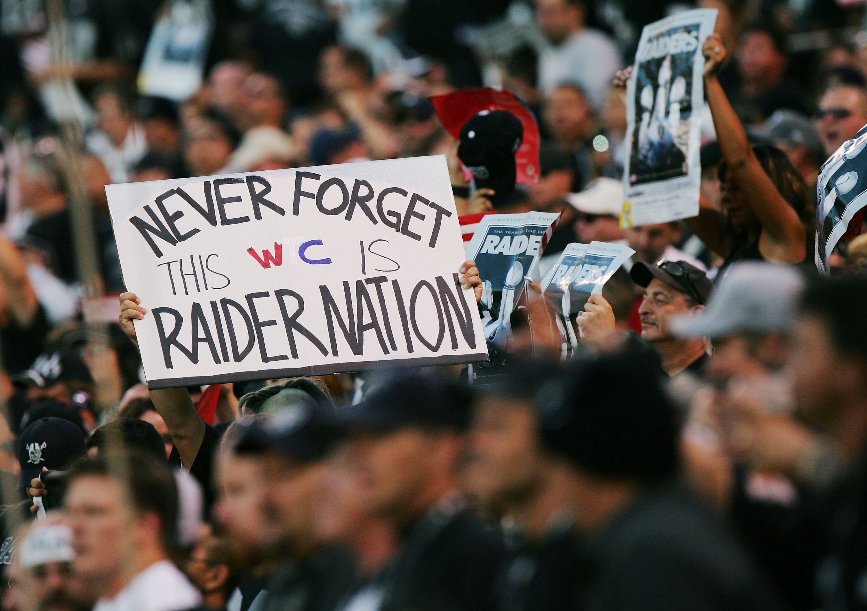 OAKLAND, CA - SEPTEMBER 11:   Fans observe a moment of silence in honor of the lives lost on September 11, 2001, before the NFL game between the Oakland Raiders and the San Diego Chargers at McAfee Coliseum on September 11, 2006 in Oakland, California.  (