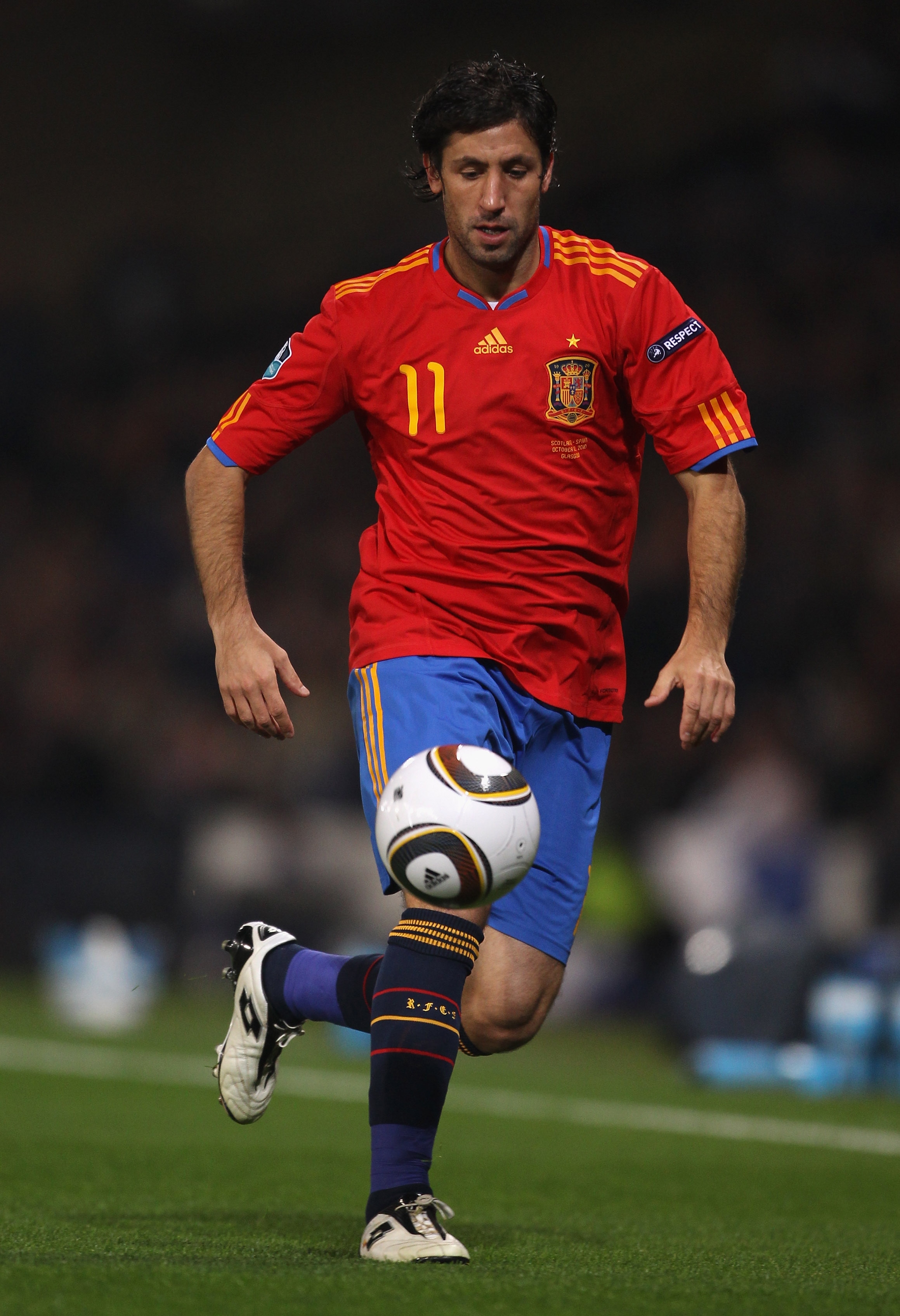 GLASGOW, SCOTLAND - OCTOBER 12: Joan Capdevila of Spain runs with the ball during the UEFA EURO 2012 Group I Qualifier match between Scotland and Spain at Hampden Park on October 12, 2010 in Glasgow, Scotland. (Photo by Alex Livesey/Getty Images)