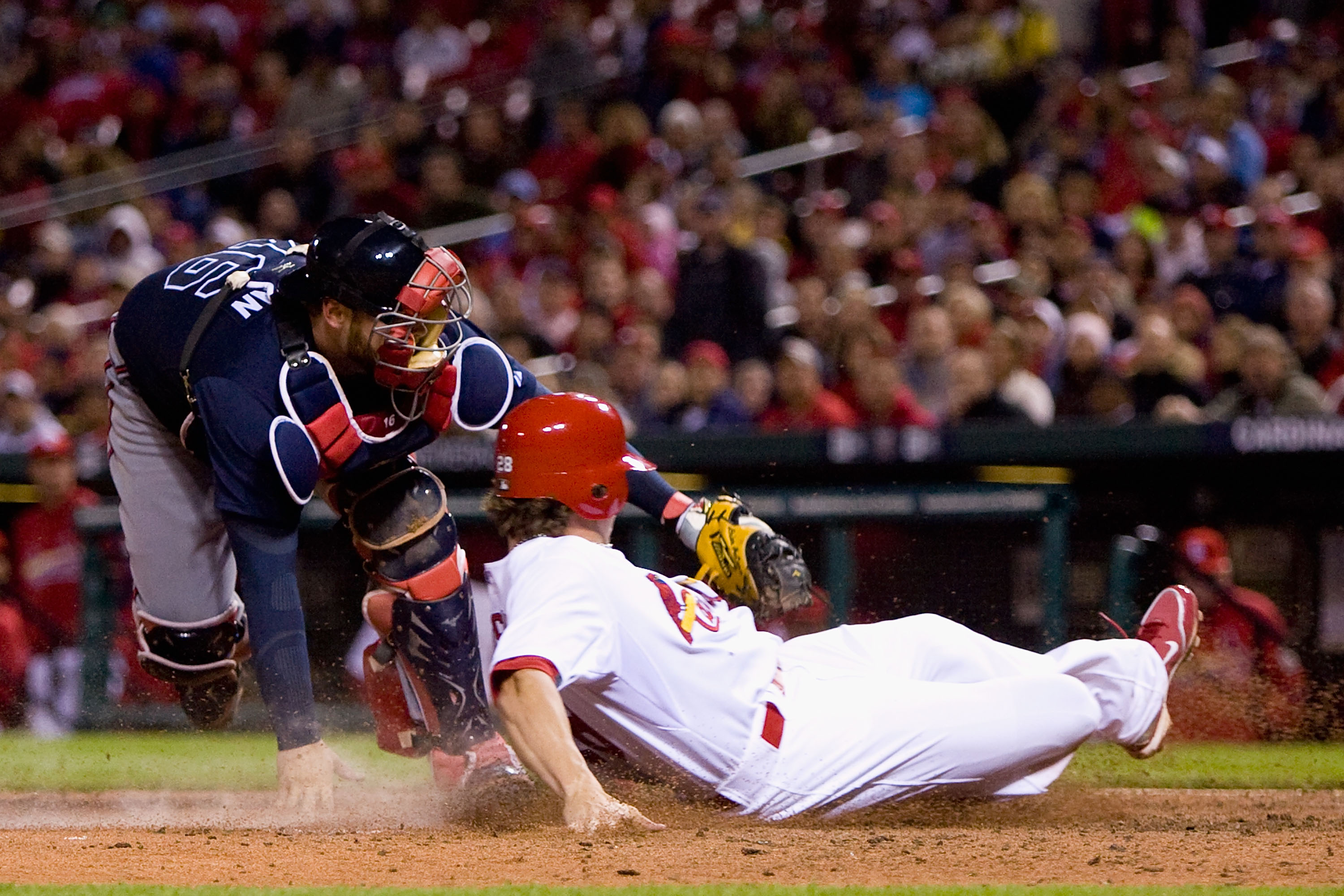 ST. LOUIS - APRIL 26: Colby Rasmus #28 of the St. Louis Cardinals is tagged out by Brian McCann #16 of the Atlanta Braves at Busch Stadium on April 26, 2010 in St. Louis, Missouri. The Cardinals beat the Braves 4-3. (Photo by Dilip Vishwanat/Getty Imag