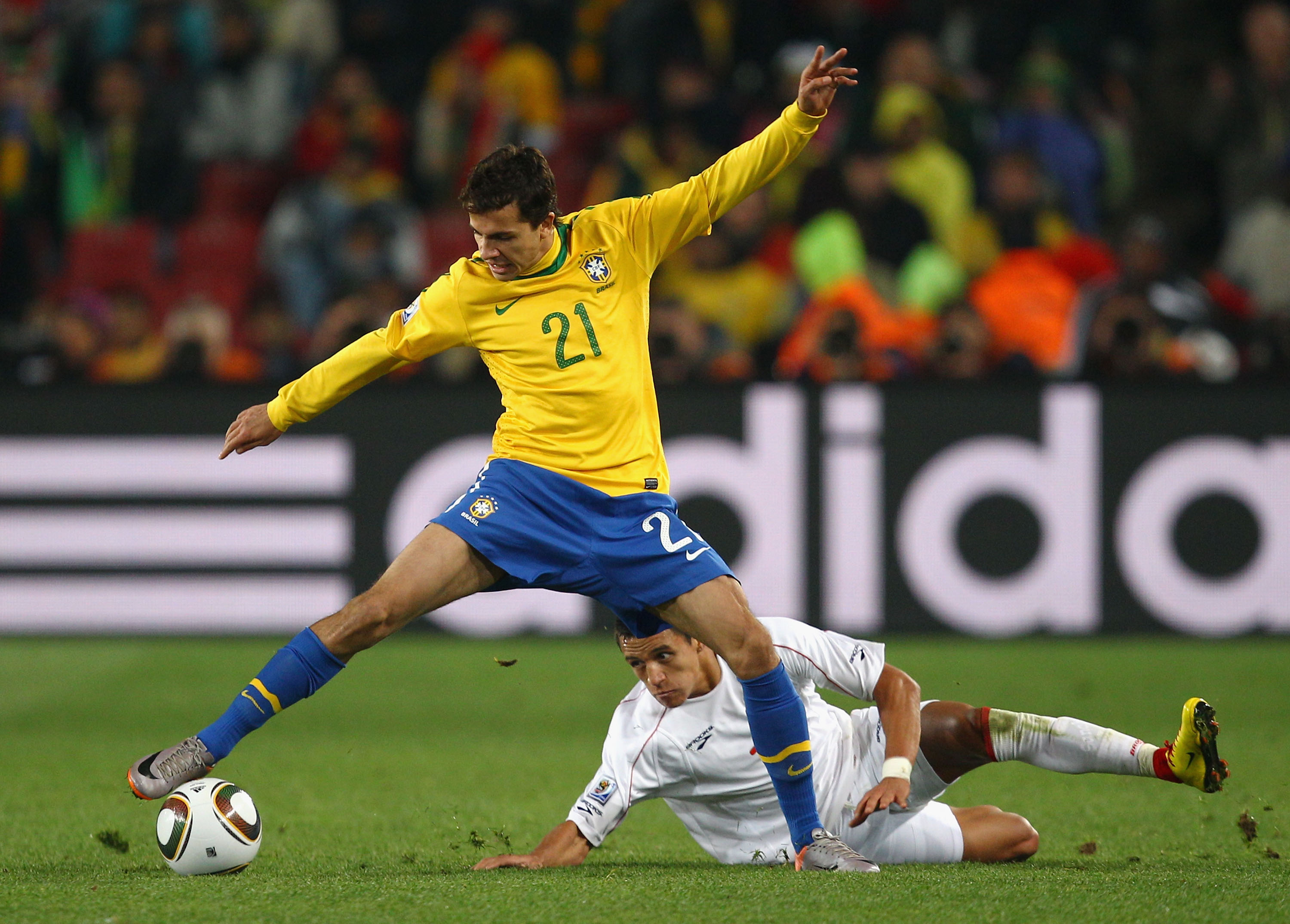 JOHANNESBURG, SOUTH AFRICA - JUNE 28: Nilmar of Brazil controls the ball with Alexis Sanchez of Chile during the 2010 FIFA World Cup South Africa Round of Sixteen match between Brazil and Chile at Ellis Park Stadium on June 28, 2010 in Johannesburg, South