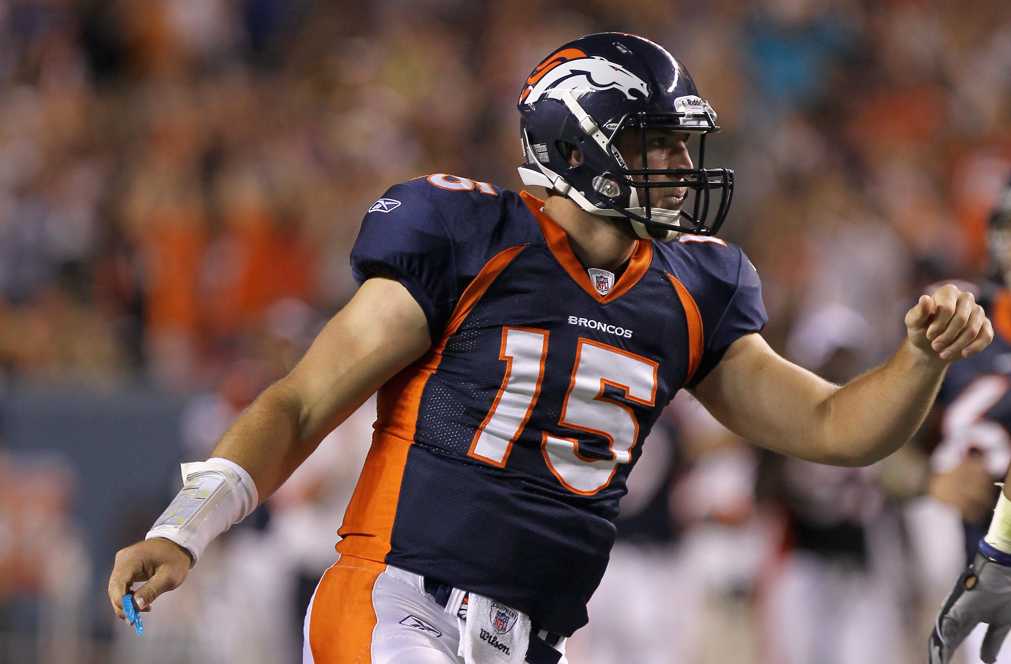 Quarterback Tim Tebow (15) celebrates a score during an NFL game