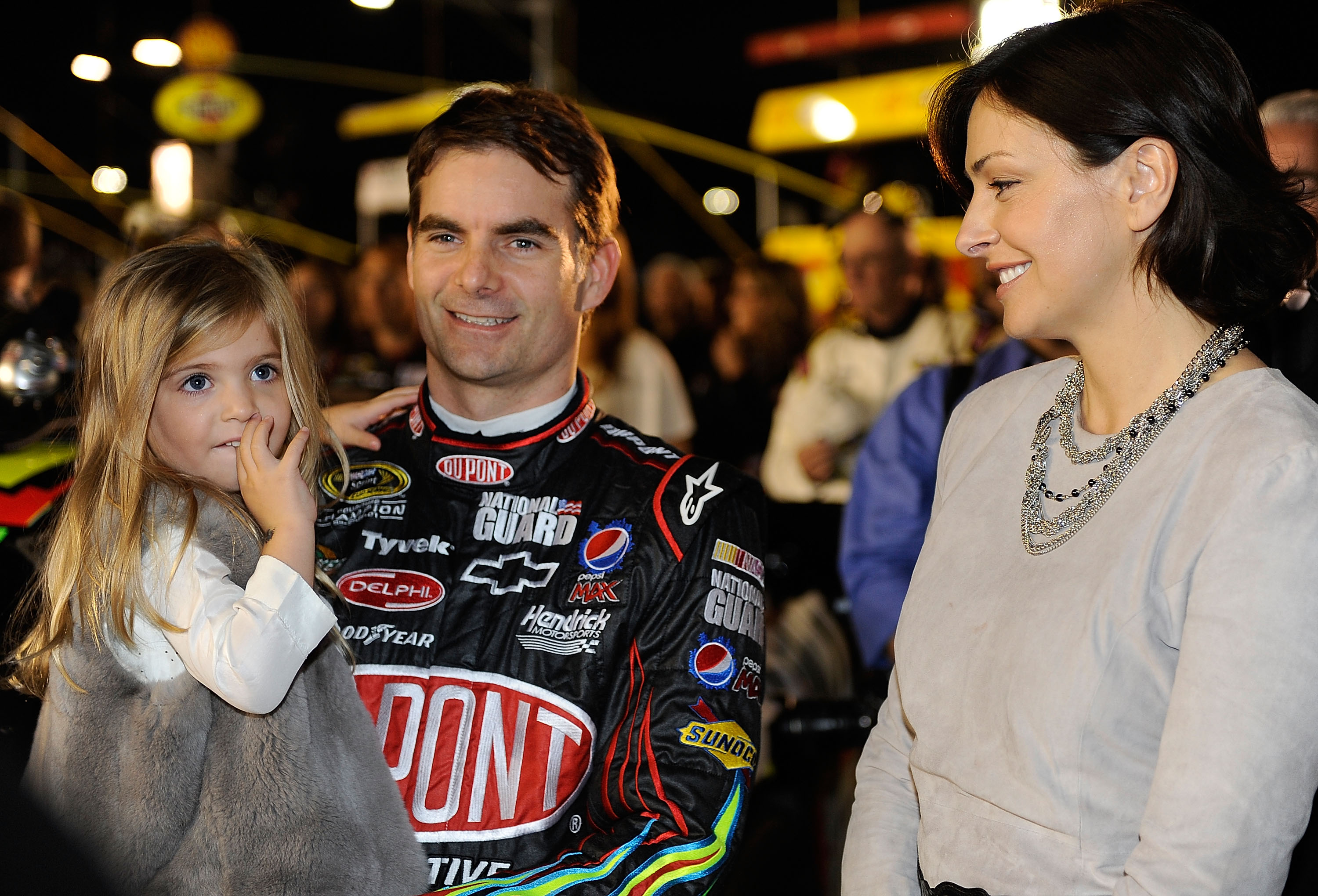 CONCORD, NC - OCTOBER 16:  Jeff Gordon (C), driver of the #24 DuPont Chevrolet, talks with daughter Ella Sophia (L) and wife Ingrid Vandebosch (R) on the grid prior to the NASCAR Sprint Cup Series Bank of America 500 at Charlotte Motor Speedway on October