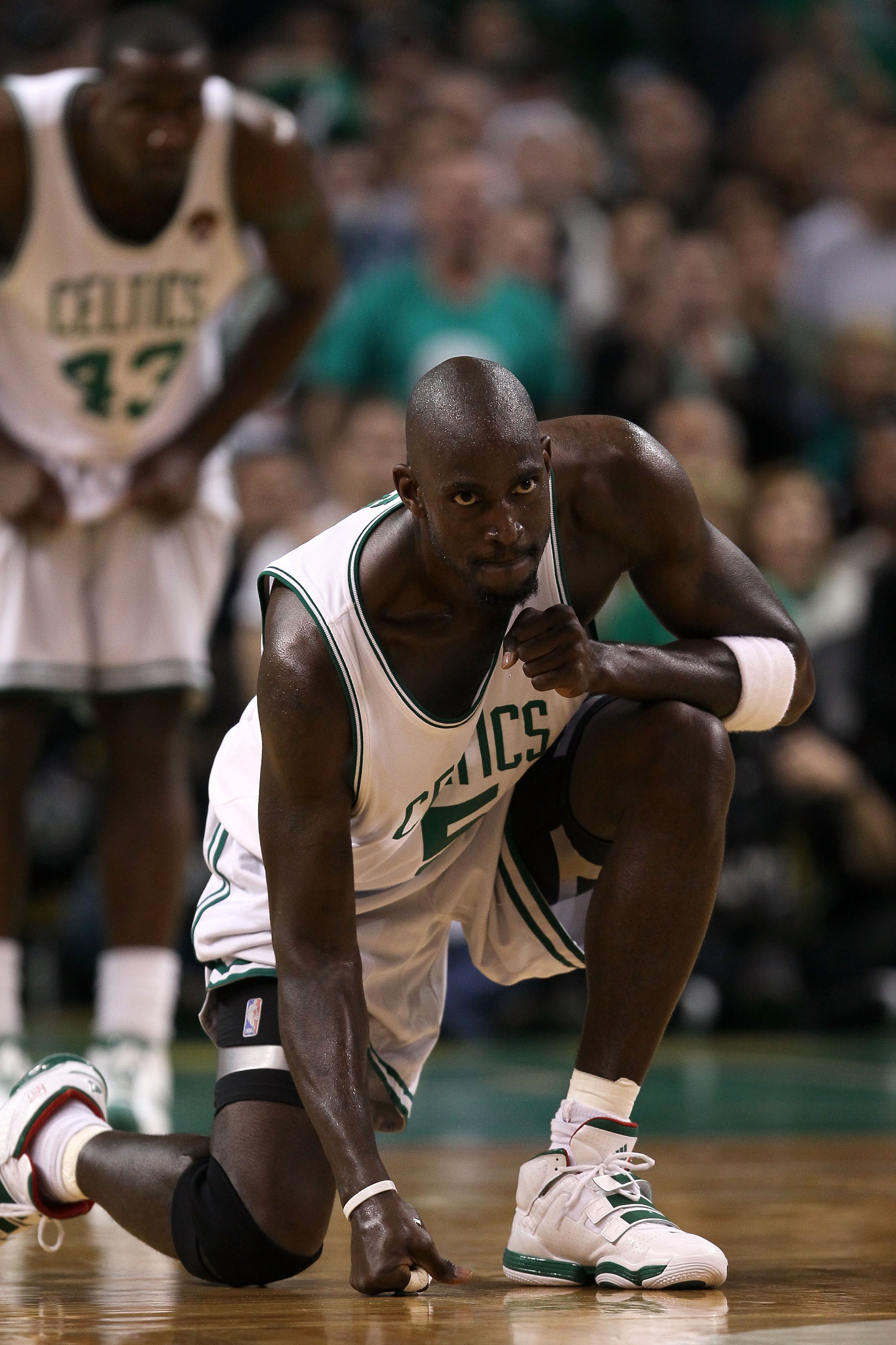 BOSTON - JUNE 10:  Kevin Garnett #5 of the Boston Celtics hits the floor as he readies himself on defense against the Los Angeles Lakers during Game Four of the 2010 NBA Finals on June 10, 2010 at TD Garden in Boston, Massachusetts. NOTE TO USER: User exp