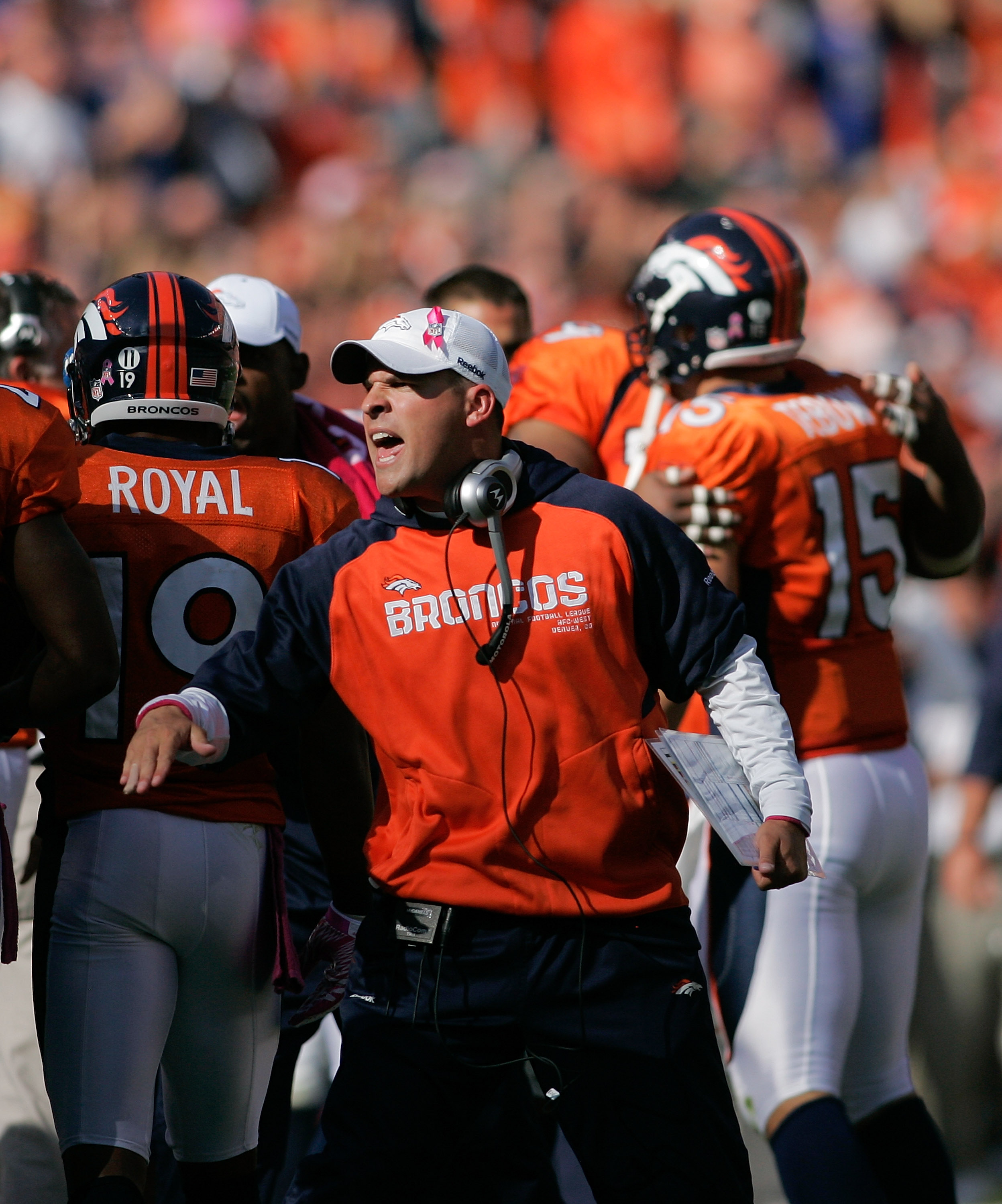 Denver Broncos quarterback Tim Tebow (15) kneels to pray with teammates and Chicago  Bears players at game's end at Sports Authority Field at Mile High on December  11, 2011 in Denver. Tebow