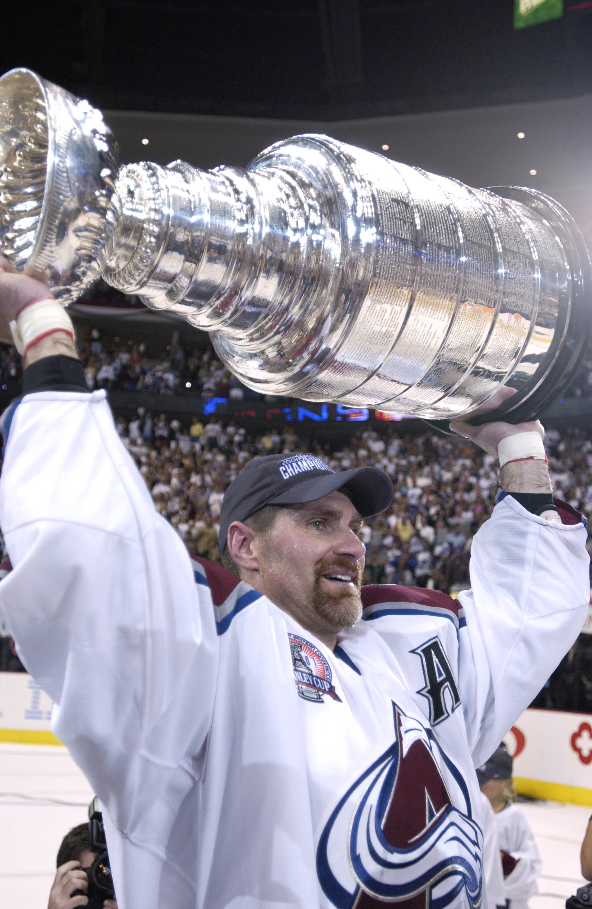 9 Jun 2001:  Ray Bourque #77 of the Colorado Avalanche lifts the Stanley Cup after they defeated the New Jersey Devils 3-1 in game seven of the NHL Stanley Cup Finals at Pepsi Center in Denver, Colorado.  The Avalanche take the series 4-3.  DIGITAL IMAGE.