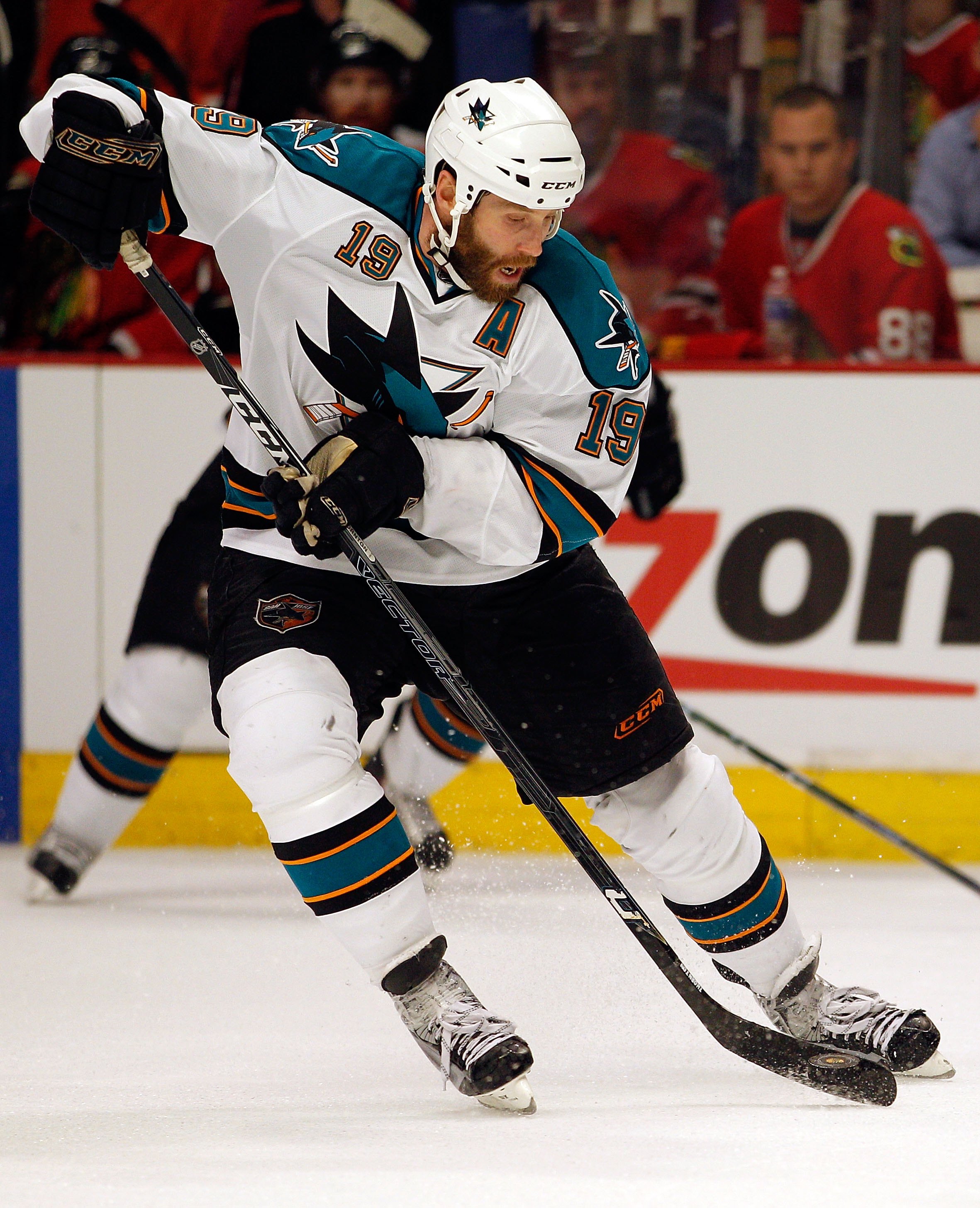 CHICAGO - MAY 21:  Joe Thornton #19 of the San Jose Sharks moves the puck while taking on the Chicago Blackhawks in Game Three of the Western Conference Finals during the 2010 NHL Stanley Cup Playoffs at the United Center on May 21, 2010 in Chicago, Illin