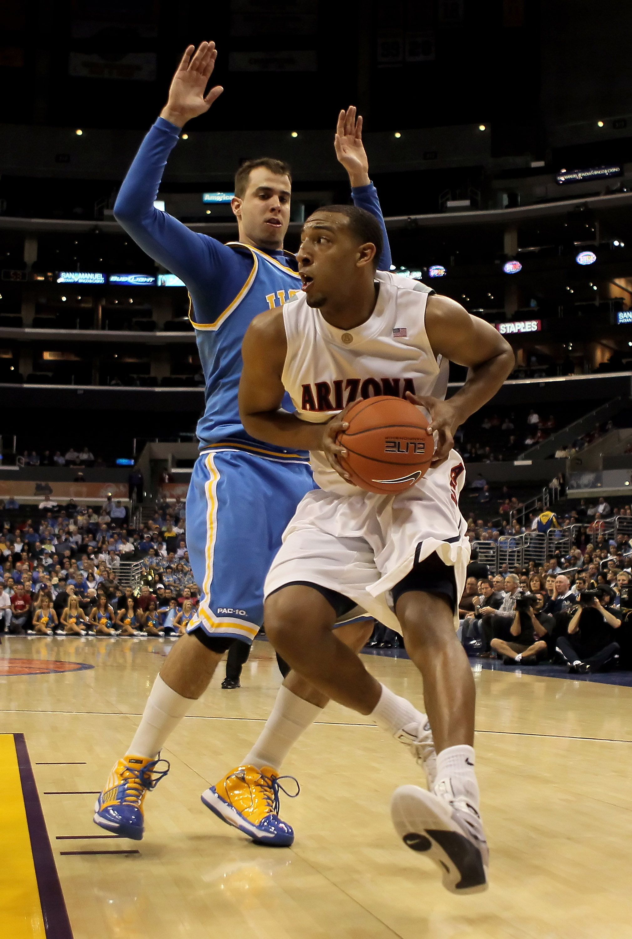 LOS ANGELES, CA - MARCH 11: Derrick Williams #23 of the Arizona Wildcats is defended by Nikola Dragovic #41 of the UCLA Bruins in the second half during the Quarterfinals of the Pac-10 Basketball Tournament at Staples Center on March 11, 2010 in Los Ange