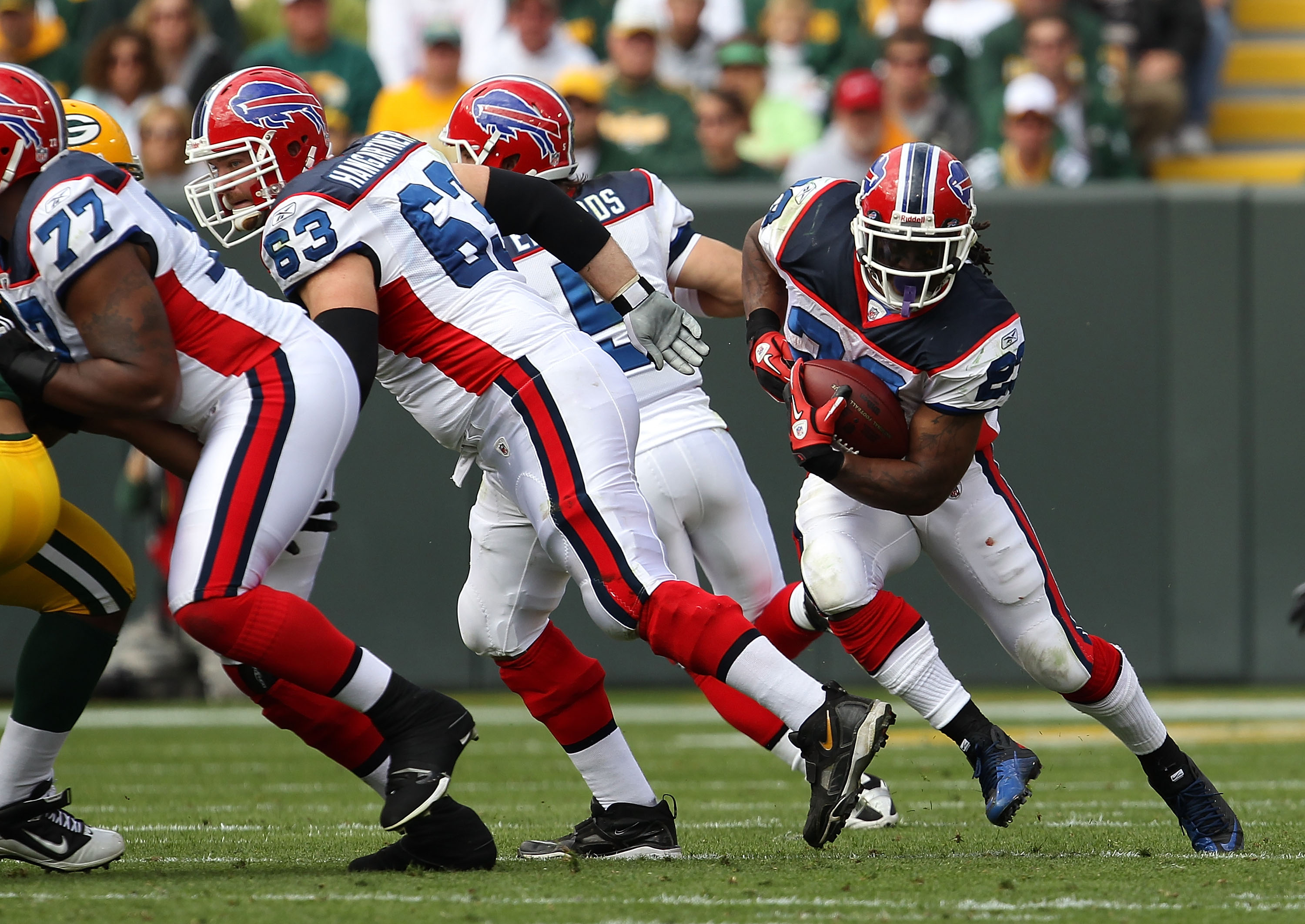 GREEN BAY, WI - SEPTEMBER 19: Marshawn Lynch #23 of the Buffalo Bills runs as teammates Demetrius Bell #77 and Geoff Hangartner #63 block against the Green Bay Packers at Lambeau Field on September 19, 2010 in Green Bay, Wisconsin. The Packers defeated th
