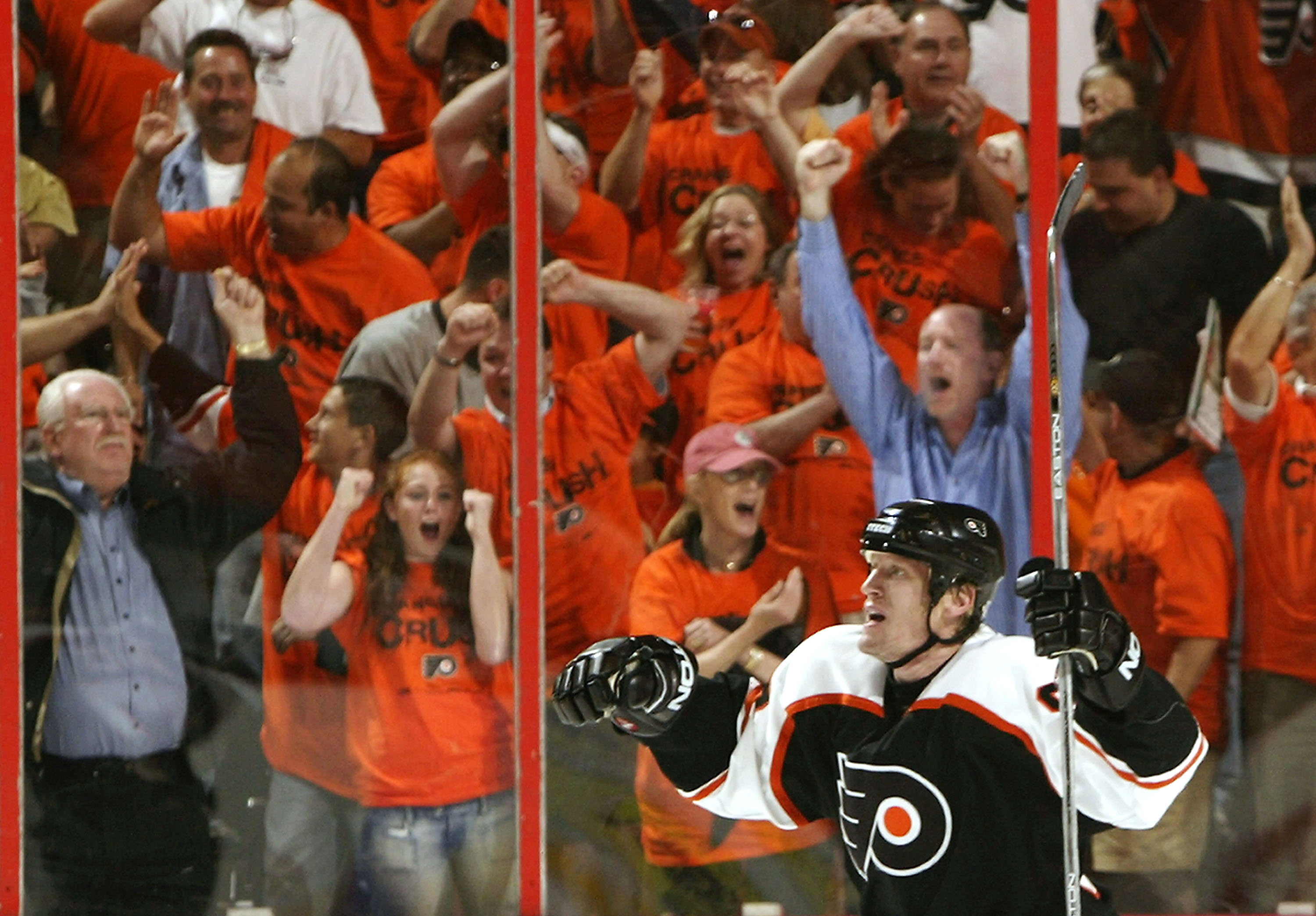 PHILADELPHIA - MAY 15:  Jeremy Roenick #97 of the Philadelphia Flyers celebrates a goal by Mark Recchi #8 against the Tampa Bay Lightning in Game four of the 2004 NHL Eastern Conference Finals on May 15, 2004 at the Wachovia Center in Philadelphia, Pennsy