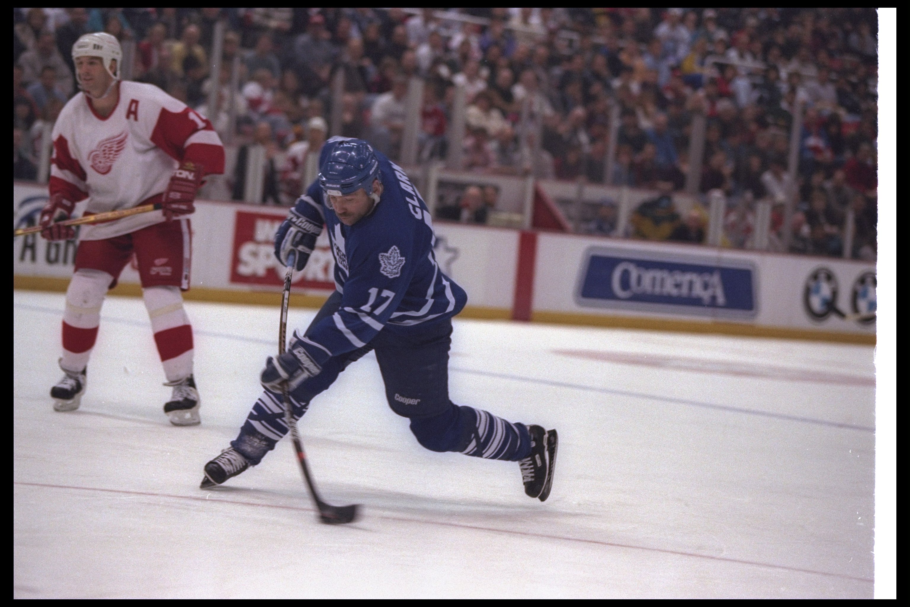 27 Nov 1996:  Leftwinger Wendel Clark of the Toronto Maple Leafs moves the puck as Detroit Red Wings player Brendan Shanahan looks on during a game at Joe Louis Arena in Detroit, Michigan.  The Red Wings won the game, 5-2. Mandatory Credit: Rick Stewart