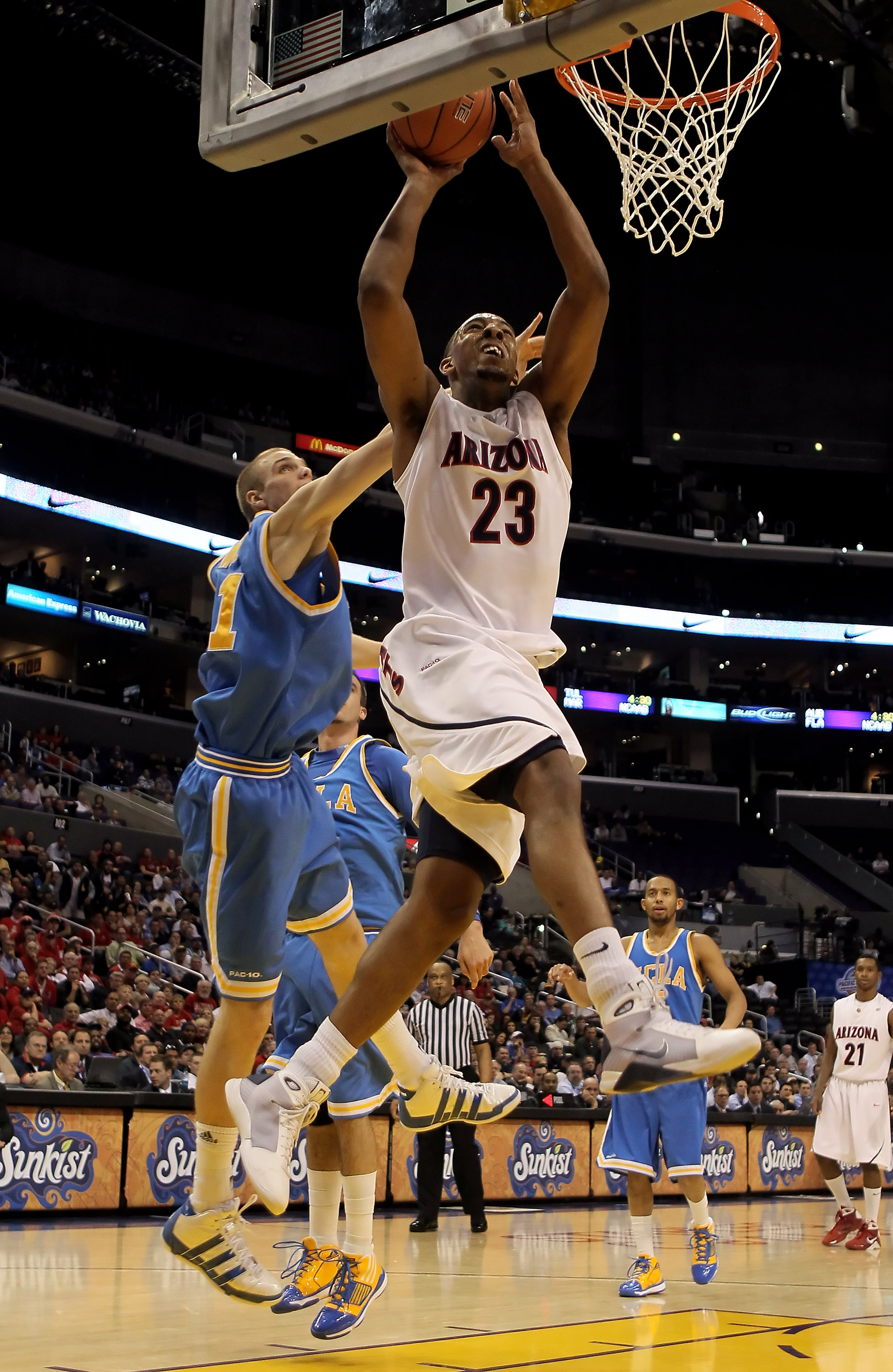 LOS ANGELES, CA - MARCH 11: Derrick Williams #23 of the Arizona Wildcats drives to the basket past Brendan Lane #21 of the UCLA Bruins in the second half during the Quarterfinals of the Pac-10 Basketball Tournament at Staples Center on March 11, 2010 in