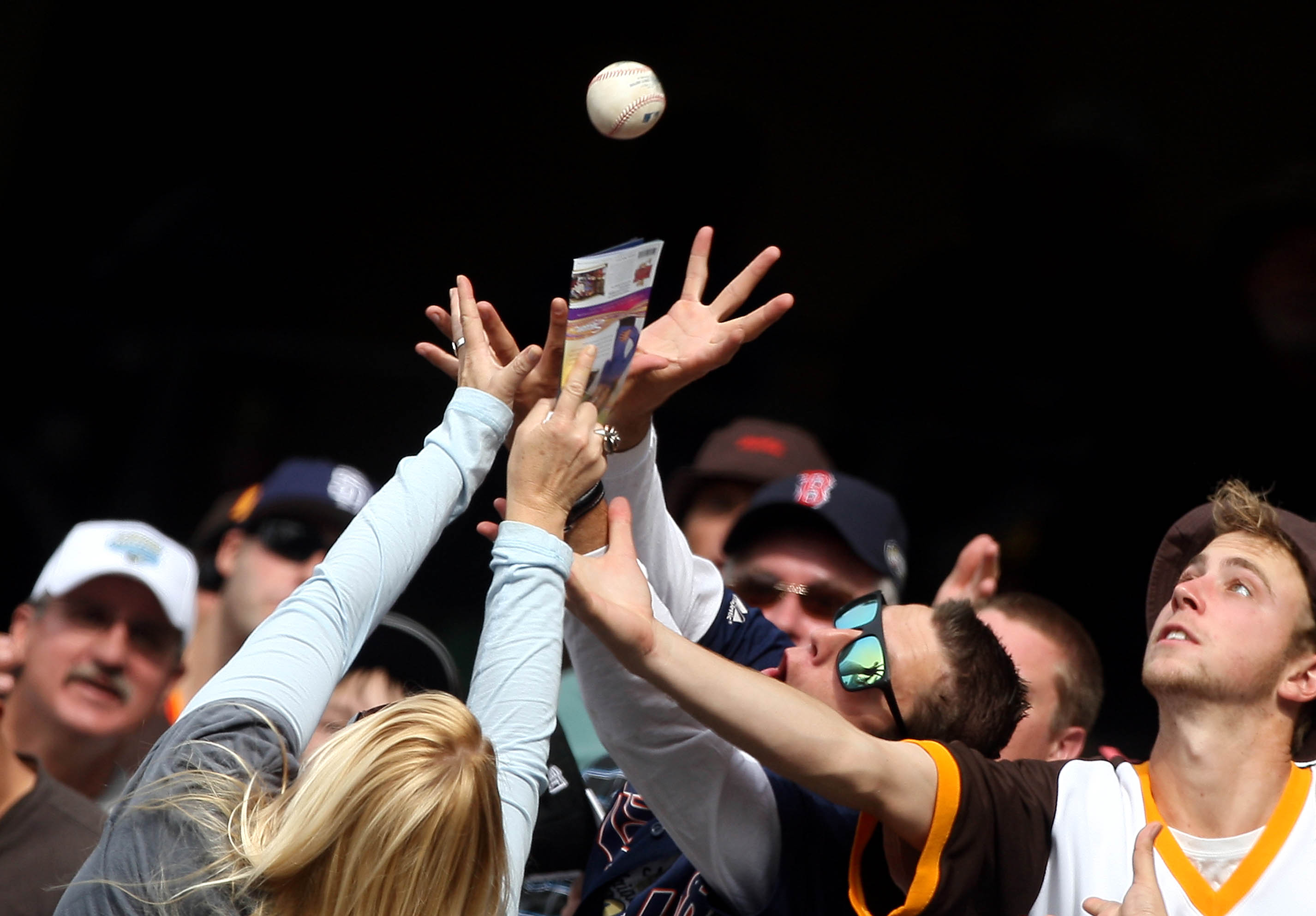 SAN DIEGO - APRIL 15:  Fans reach for a fly ball during a game between the Atlanta Braves and the San Diego Padres at Petco Park on April 15, 2010 in San Diego, California. (Photo by Donald Miralle/Getty Images)