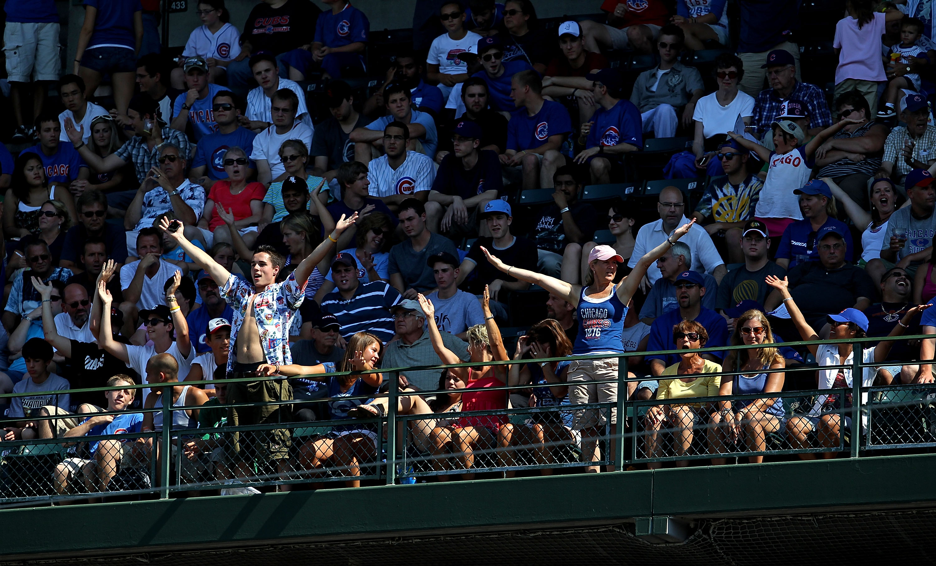 CHICAGO - JULY 21: Fans in the upper deck do a dance to the song 'YMCA' during a pitching change as the Chicago Cubs take on the Houston Astros at Wrigley Field on July 21, 2010 in Chicago, Illinois. The Astros defeated the Cubs 4-3 in 12 innings. (Photo