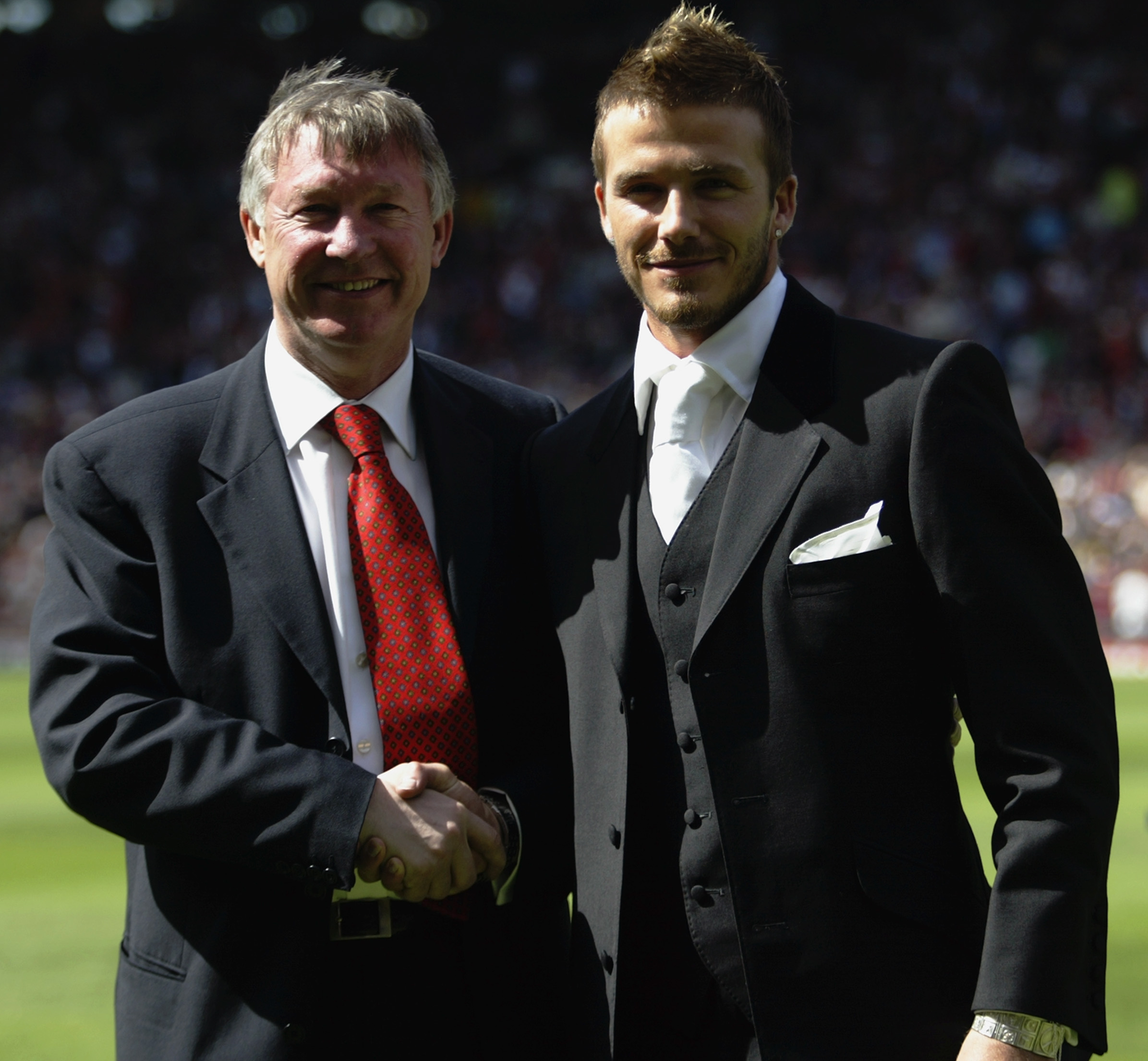 MANCHESTER - MAY 11:  David Beckham of Manchester United and manager Alex Ferguson stand next to each other on the pitch after Beckham signed a new lucrative contract to stay at the club before the FA Barclaycard Premiership match between Manchester Unite