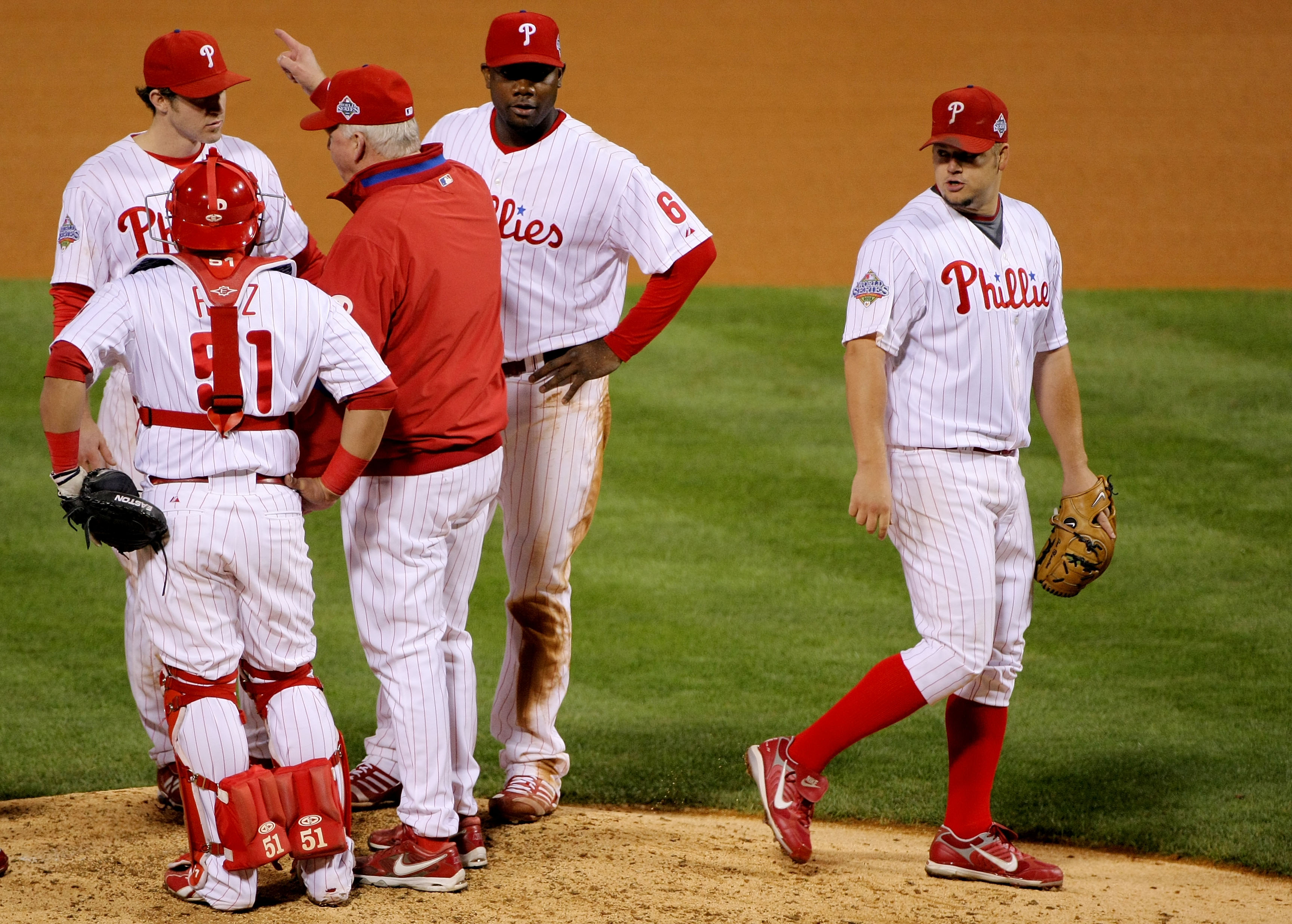 PHILADELPHIA - OCTOBER 26:  Joe Blanton #56 of the Philadelphia Phillies is pulled out of the game by manager Charlie Manuel while teammates Carlos Ruis #51, Chase Utley #26 and Ryan Howard #6 stand on the mound against the Tampa Bay Rays during game four