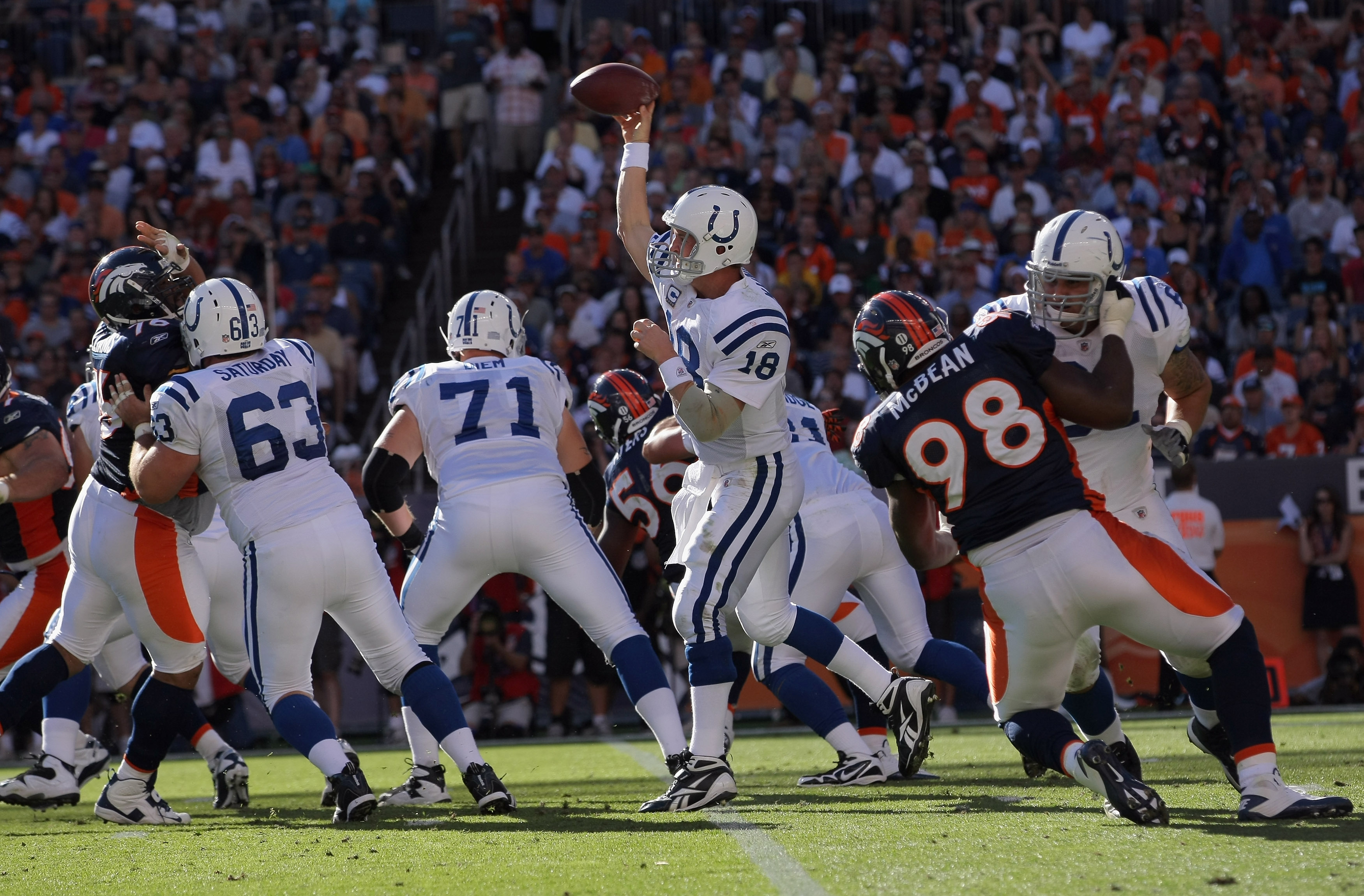 DENVER - SEPTEMBER 26:  Quarterback Peyton Manning #18 of the Indianapolis Colts is protected by his offense line as he delivers a pass against the Denver Broncos at INVESCO Field at Mile High on September 26, 2010 in Denver, Colorado. The Colts defeated