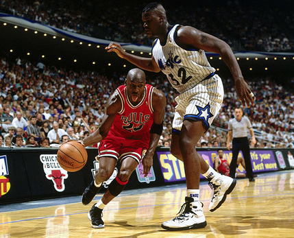 Jordan driving past a young Shaquille O'Neal