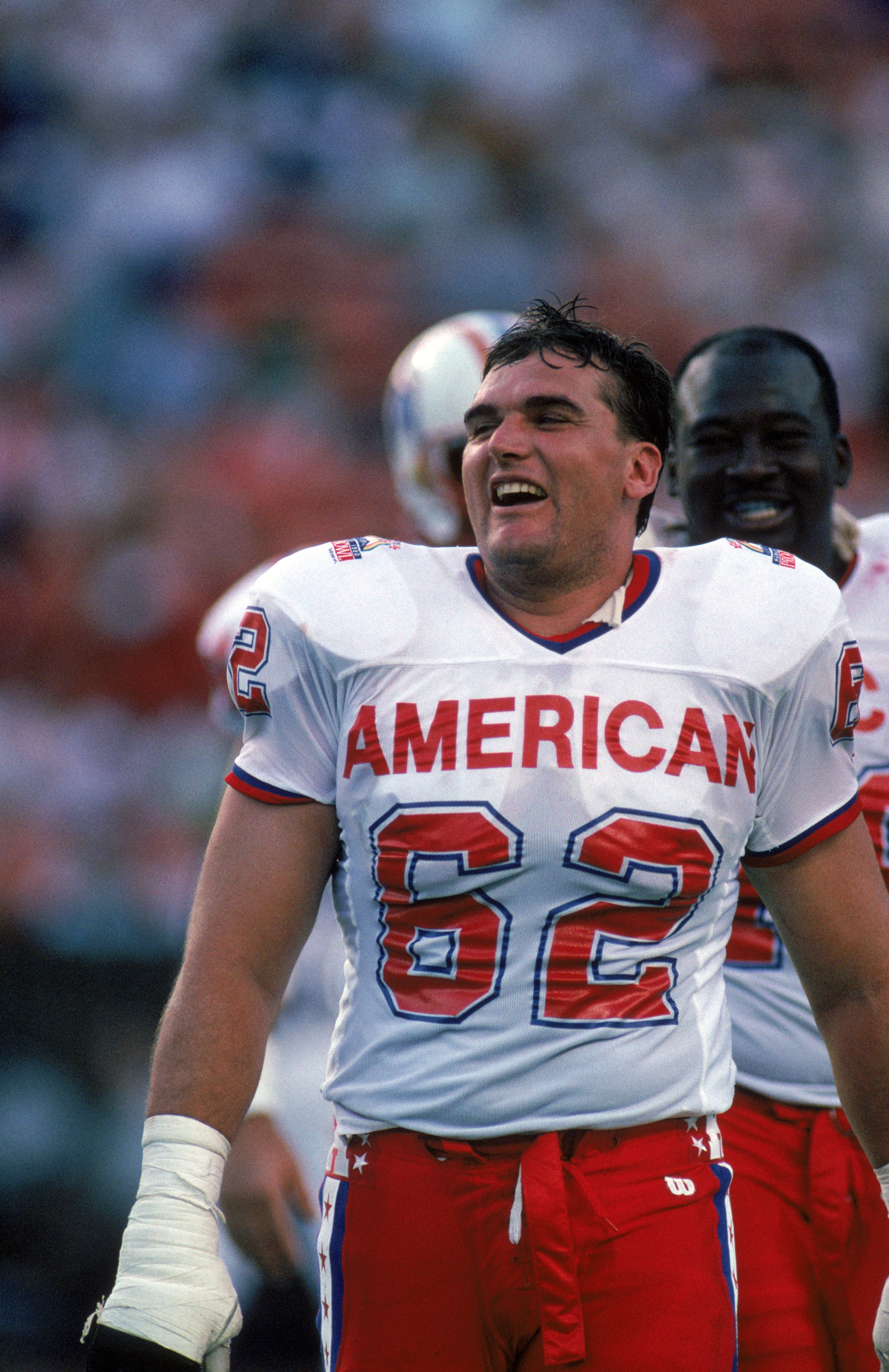 HONOLULU, HI - FEBRUARY 4:  Buffalo Bills offensive tackle Tunch Ilkin #62 of the AFC squad laughs during the 1990 NFL Pro Bowl at Aloha Stadium on February 4, 1990 in Honolulu, Hawaii.  The NFC won 27-21.  (Photo by George Rose/Getty Images)