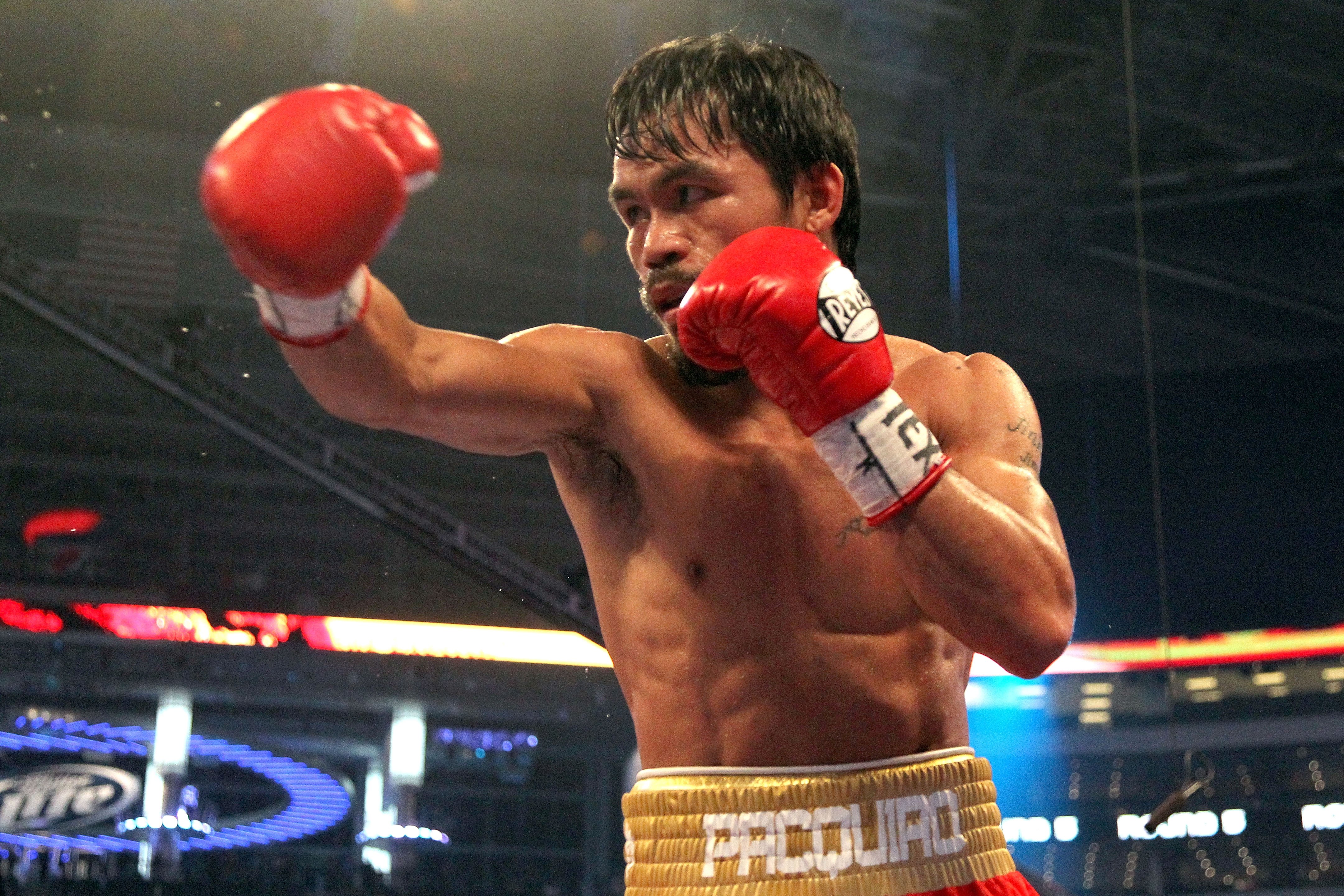 ARLINGTON, TX - MARCH 13:  Manny Pacquiao of the Philippines throws a punch in the ring against Joshua Clottey of Ghana during the WBO welterweight title fight at Cowboys Stadium on March 13, 2010 in Arlington, Texas. Pacquiao defeated Clottey by unanimou