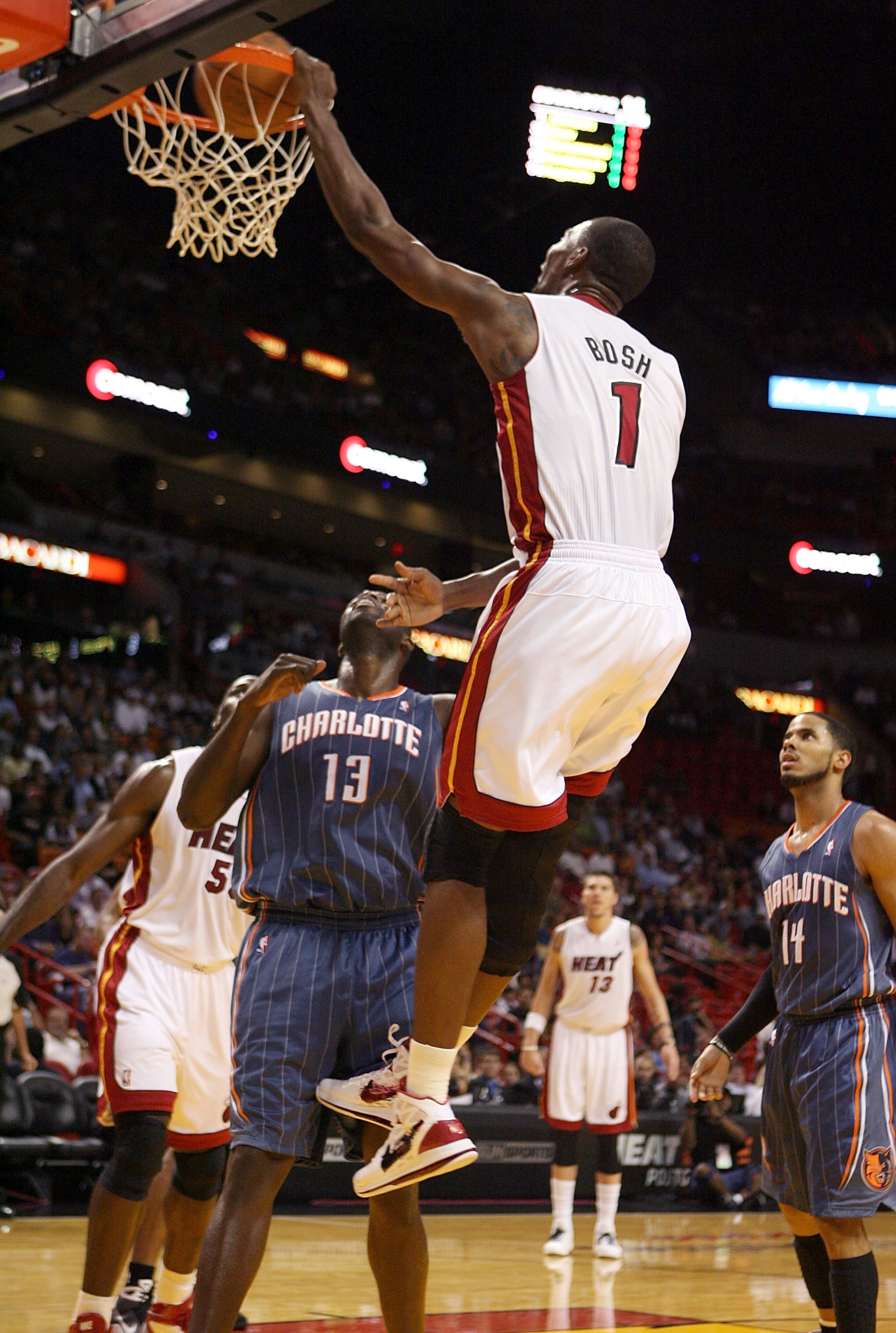 MIAMI - OCTOBER 18:  Center Chris Bosh #1 of the Miami Heat dunks over center Nazr Mohammed #13 of the Charlotte Bobcats on October 18, 2010 at the American Airlines arena in Miami, Florida.  NOTE TO USER: User expressly acknowledges and agrees that, by d