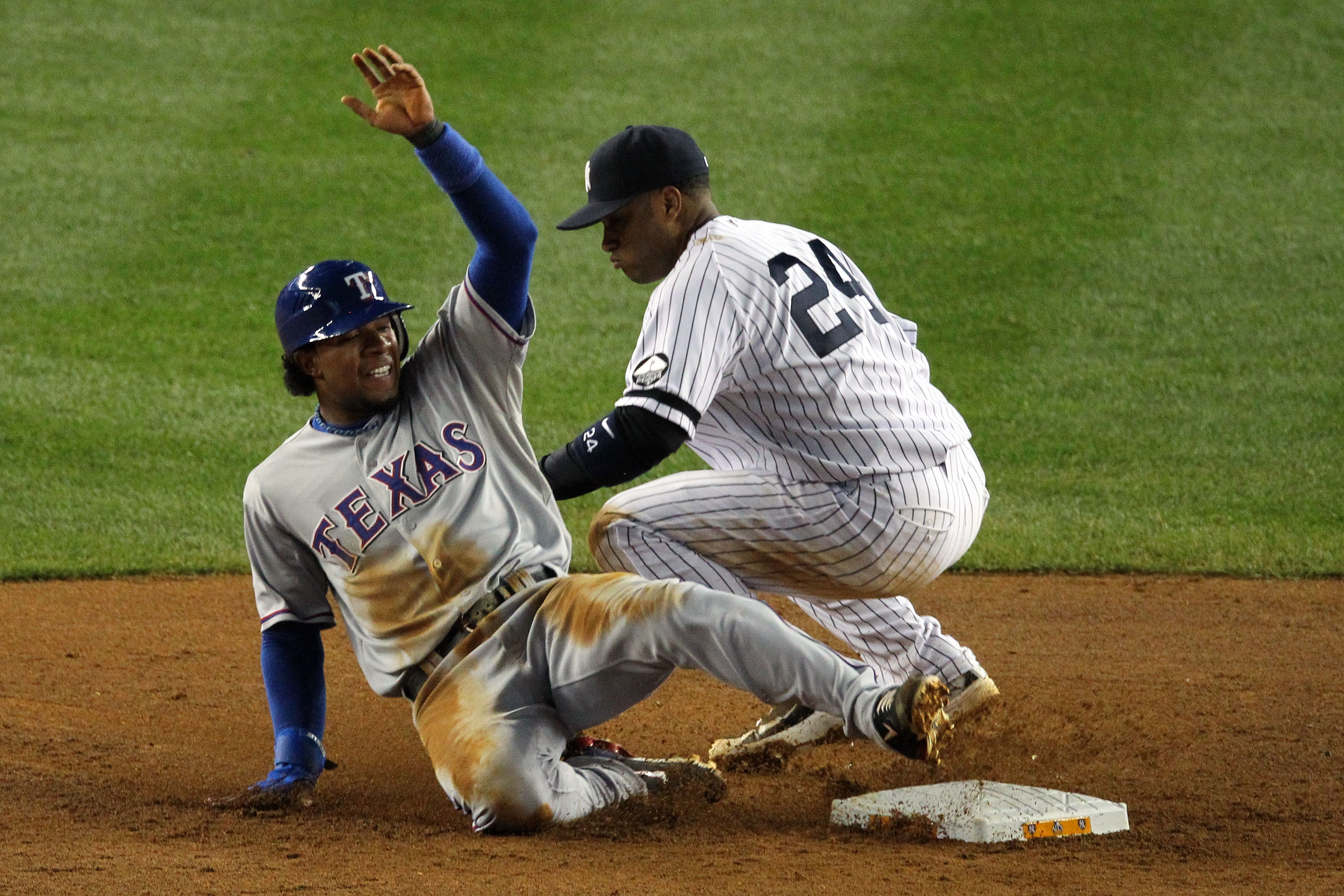 NEW YORK - OCTOBER 19: Elvis Andrus #1 of the Texas Rangers steals second base against Robinson Cano #24 of the New York Yankees in Game Four of the ALCS during the 2010 MLB Playoffs at Yankee Stadium on October 19, 2010 in the Bronx borough of New York C