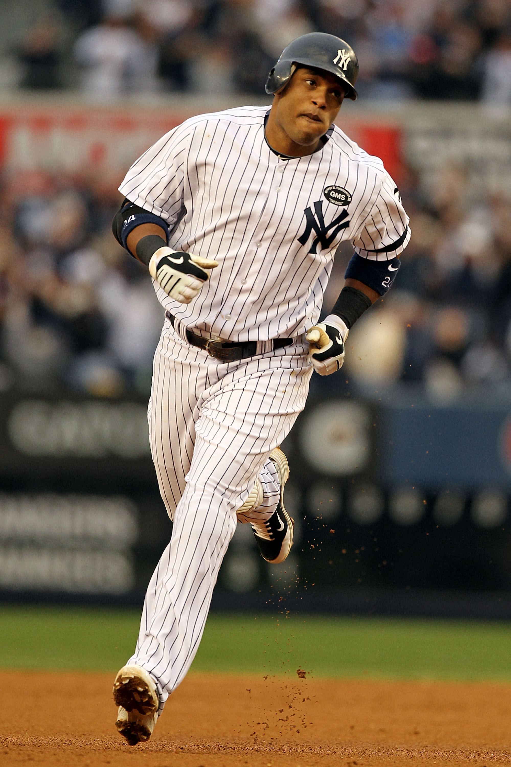 NEW YORK - OCTOBER 20:  Robinson Cano #24 of the New York Yankees rounds the bases after hitting a solo homerun in the third inning against the Texas Rangers in Game Five of the ALCS during the 2010 MLB Playoffs at Yankee Stadium on October 20, 2010 in th
