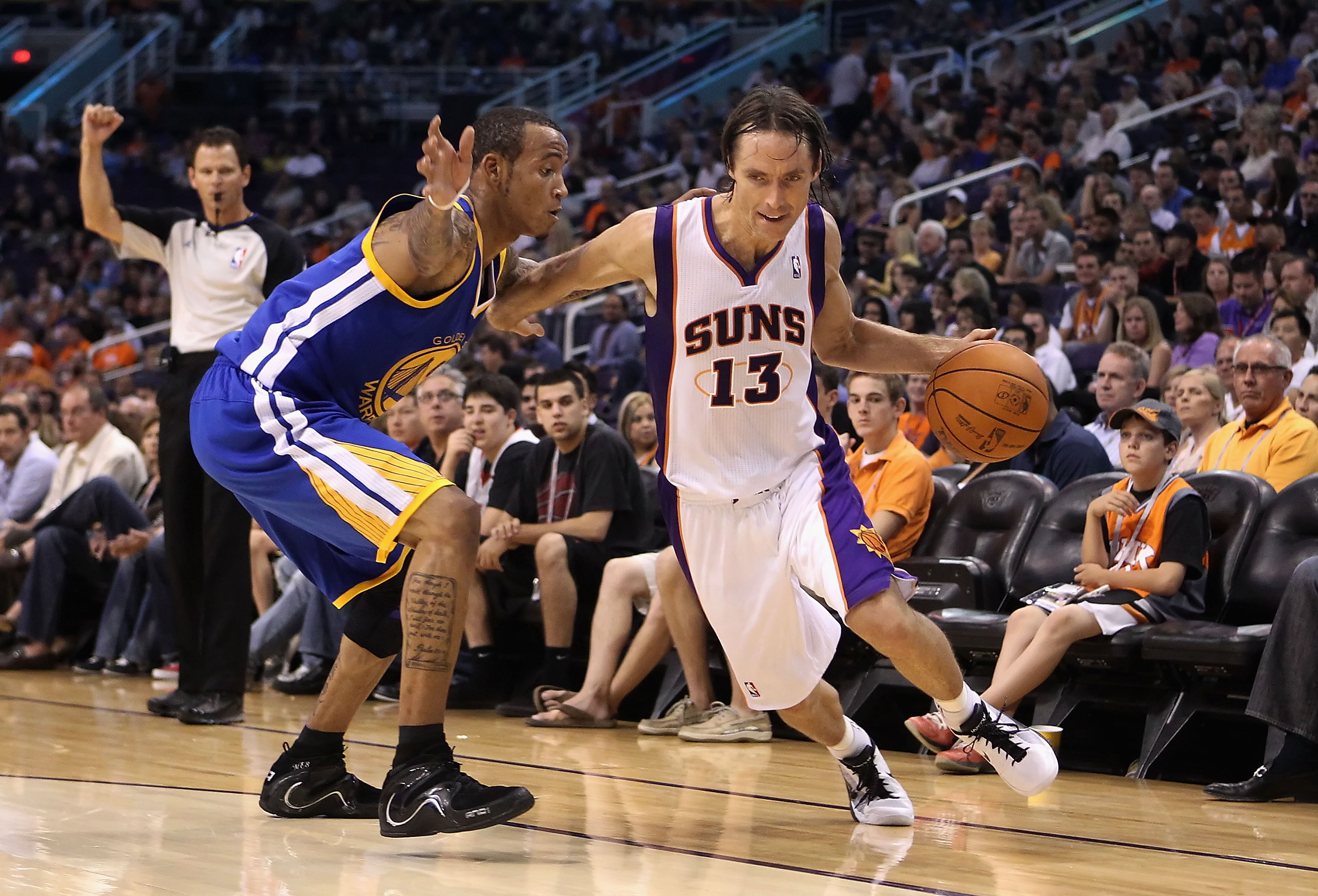 PHOENIX - OCTOBER 19: Steve Nash #13 of the Phoenix Suns drives the ball past Monta Ellis #8 of the Golden State Warriors during the preseason NBA game at US Airways Center on October 19, 2010 in Phoenix, Arizona. NOTE TO USER: User expressly acknowledge