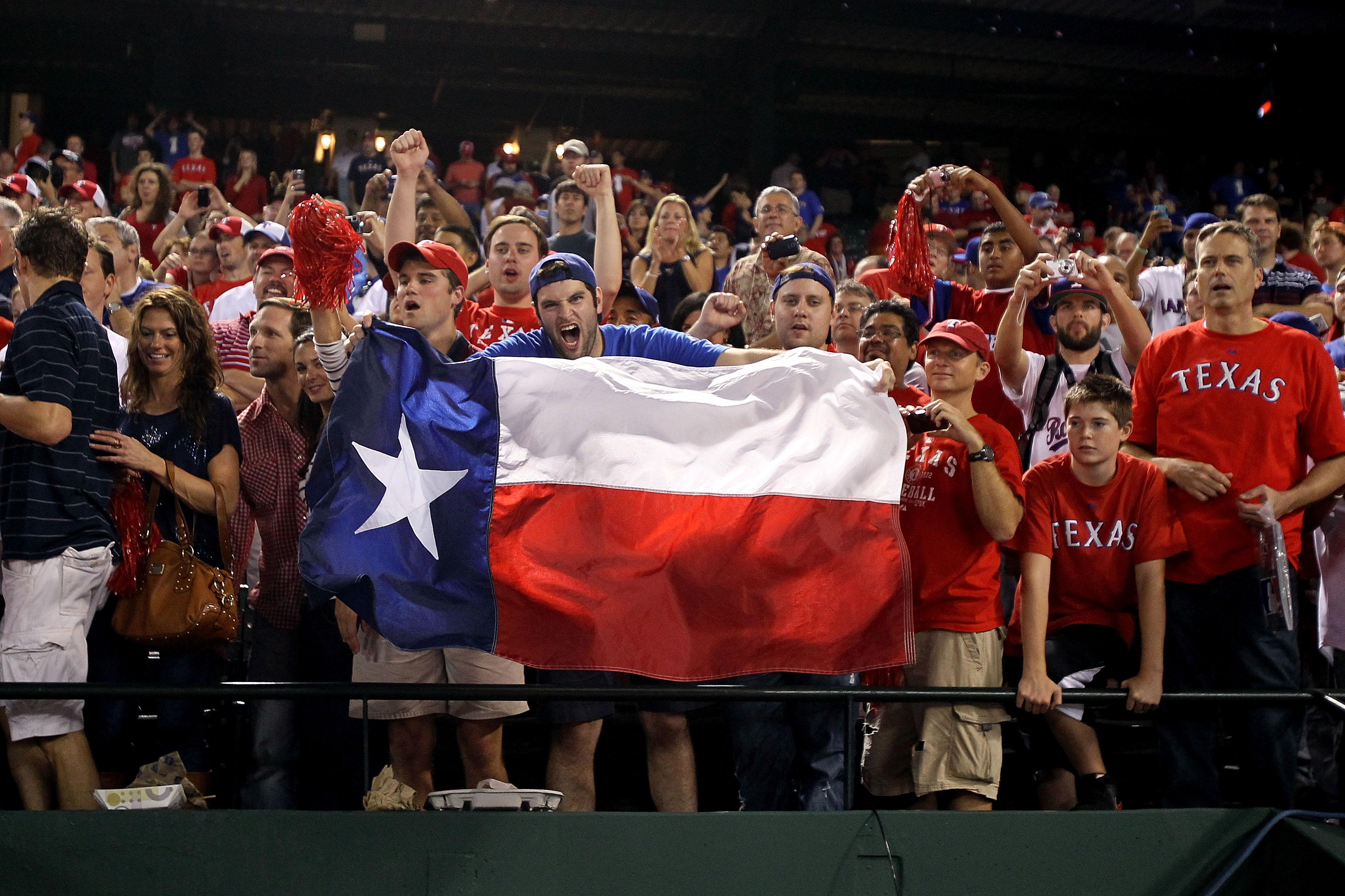 ARLINGTON, TX - OCTOBER 22:  Fans of the Texas Rangers holds a Texas state flag during Game Six of the ALCS against the New York Yankees during the 2010 MLB Playoffs at Rangers Ballpark in Arlington on October 22, 2010 in Arlington, Texas.  (Photo by Step