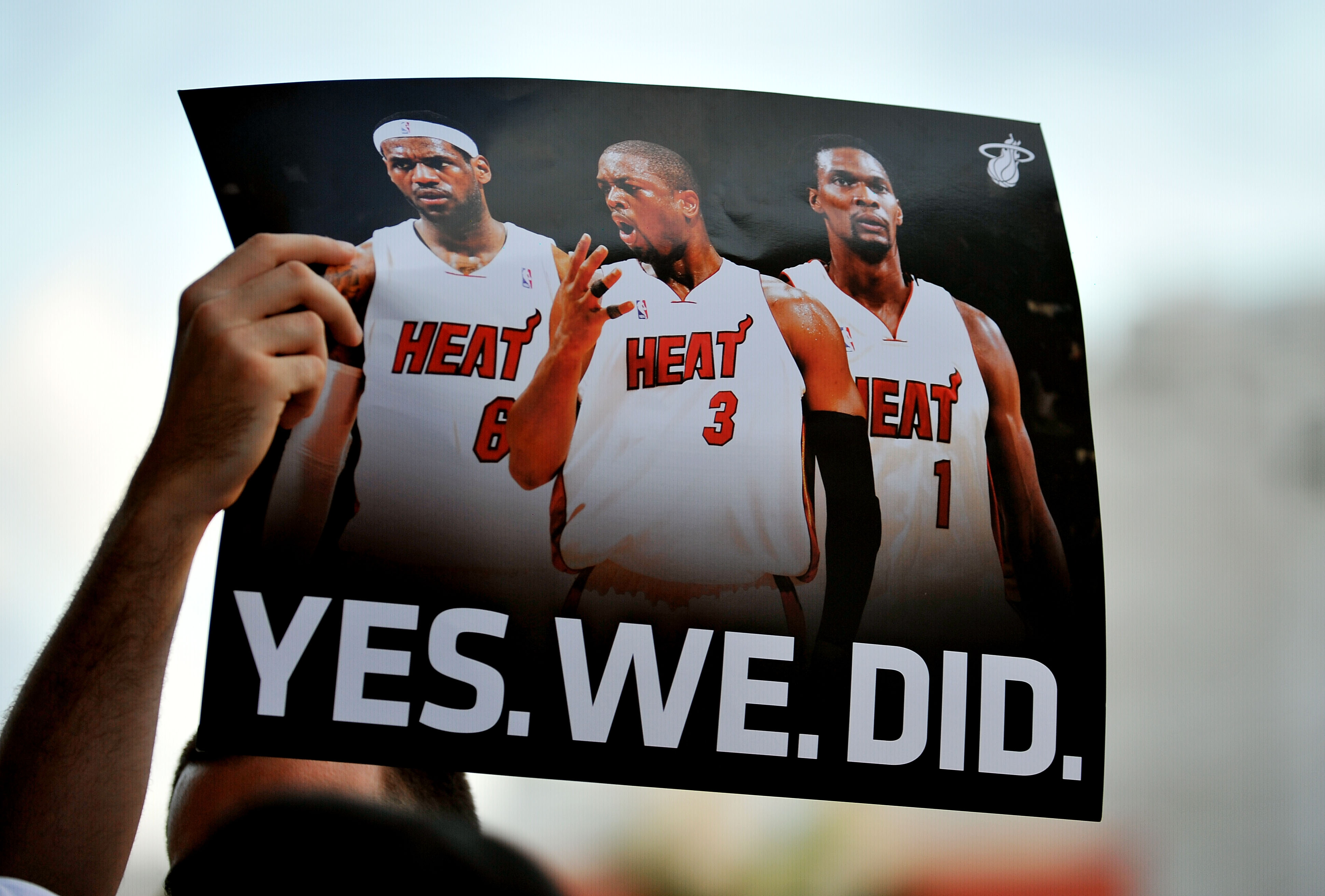 MIAMI - JULY 09:  A fan holds up a poster  of Chris Bosh #1, Dwyane Wade #3 and LeBron James #6 of the Miami Heat before the start of a welcome party for the new players at American Airlines Arena on July 9, 2010 in Miami, Florida.  (Photo by Doug Benc/Ge