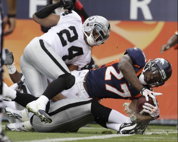 24 October 2010: Oakland Raiders running back Darren McFadden (20) runs  with the ball. The Oakland Raiders defeated the Denver Broncos by a score  of 59 to 14 at Invesco Field at