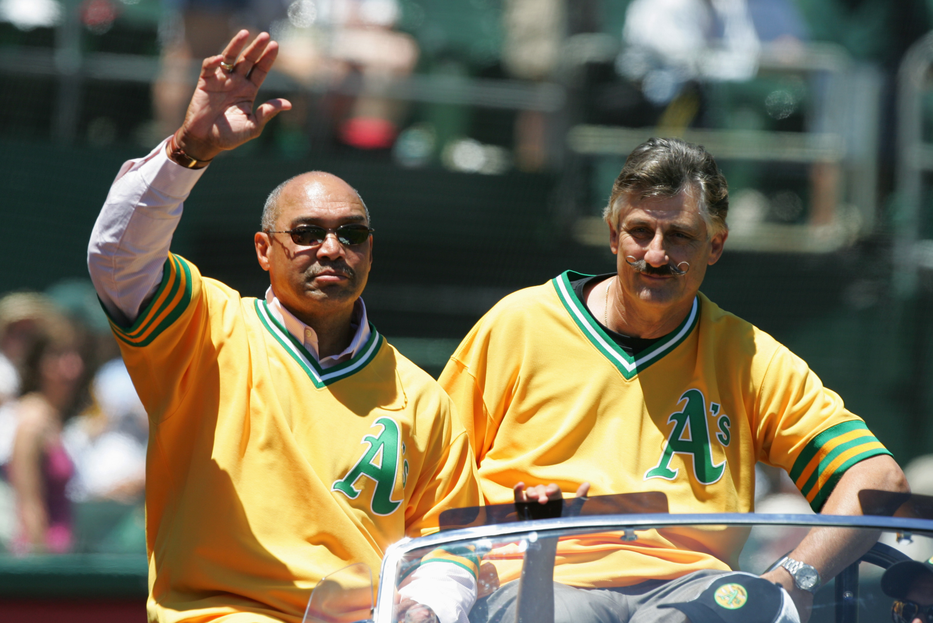 Reggie Jackson waves during a celebration of the Oakland Athletics' 1972  World Series winning team before a baseball game between the Athletics and  the Boston Red Sox in Oakland, Calif., Saturday, June