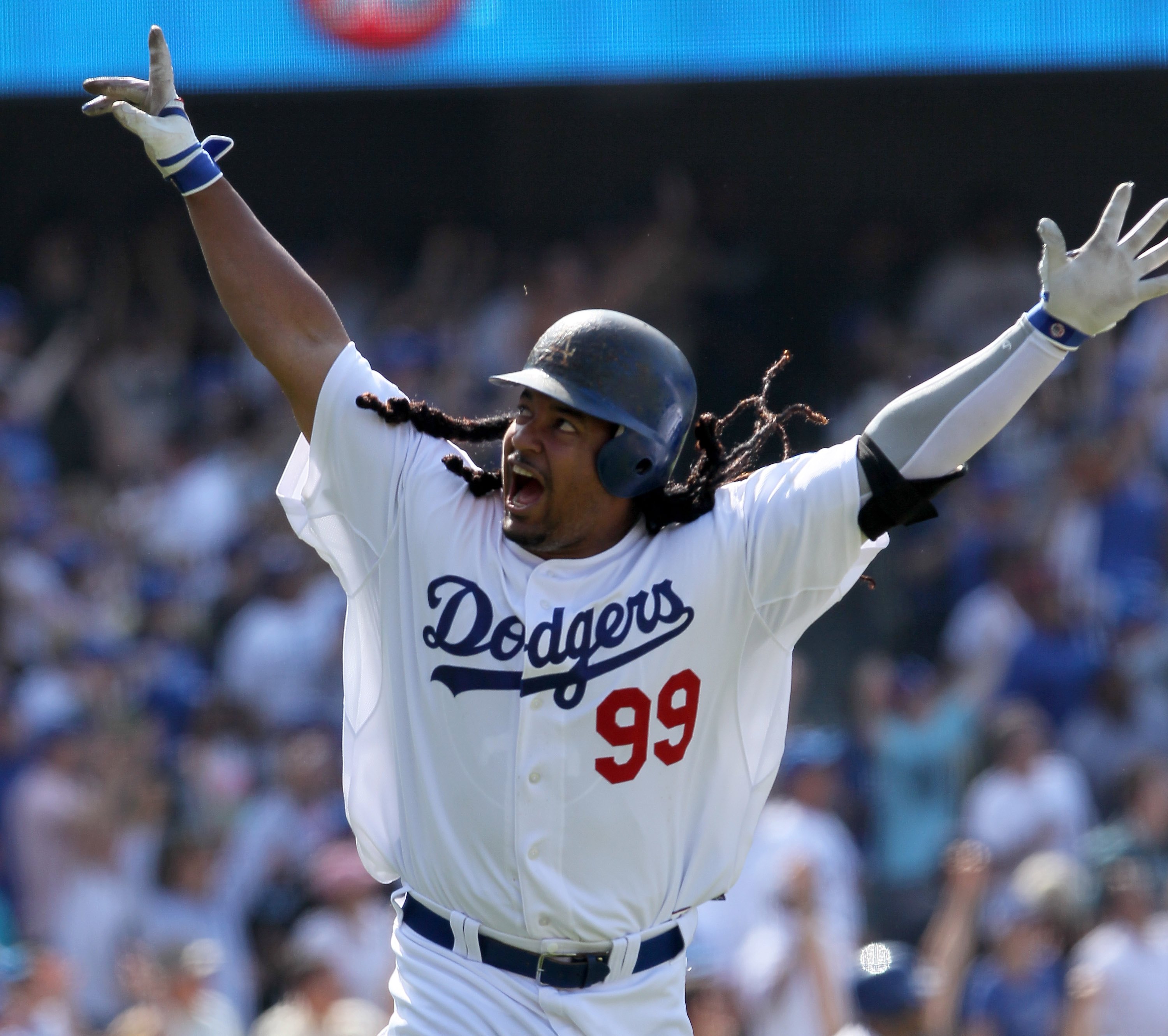 LOS ANGELES, CA - APRIL 18:  Manny Ramirez #99 of the Los Angeles Dodgers celebrates after hitting a two-run homerun in the eighth inning against the San Francisco Giants at Dodger Stadium on April 18, 2010 in Los Angeles, California. The Dodgers defeated