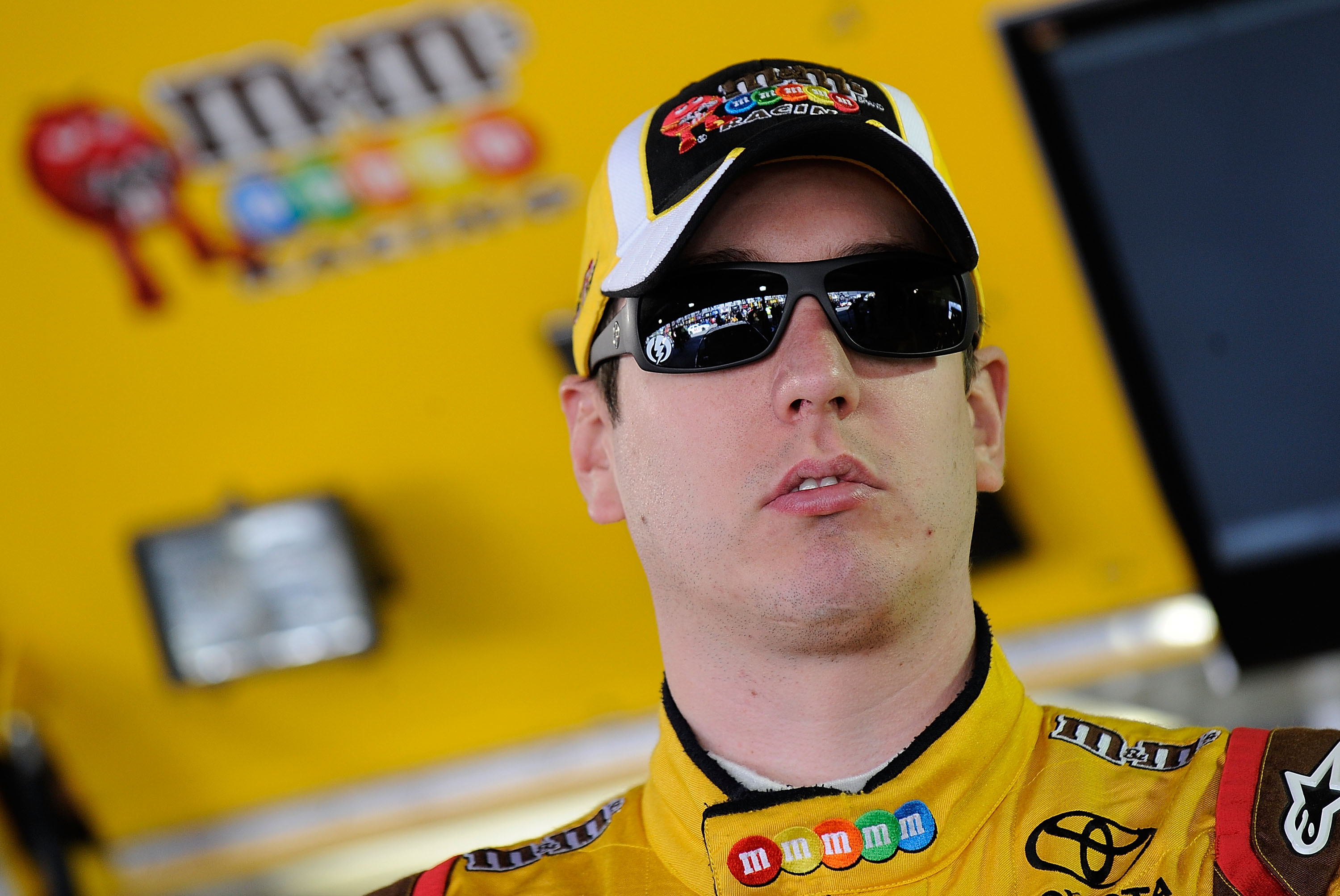 MARTINSVILLE, VA - OCTOBER 22:  Kyle Busch, driver of the #18 M&M's Toyota, stands in the garage prior to practice for the NASCAR Sprint Cup Series TUMS Fast Relief 500 at Martinsville Speedway on October 22, 2010 in Martinsville, Virginia.  (Photo by Rus