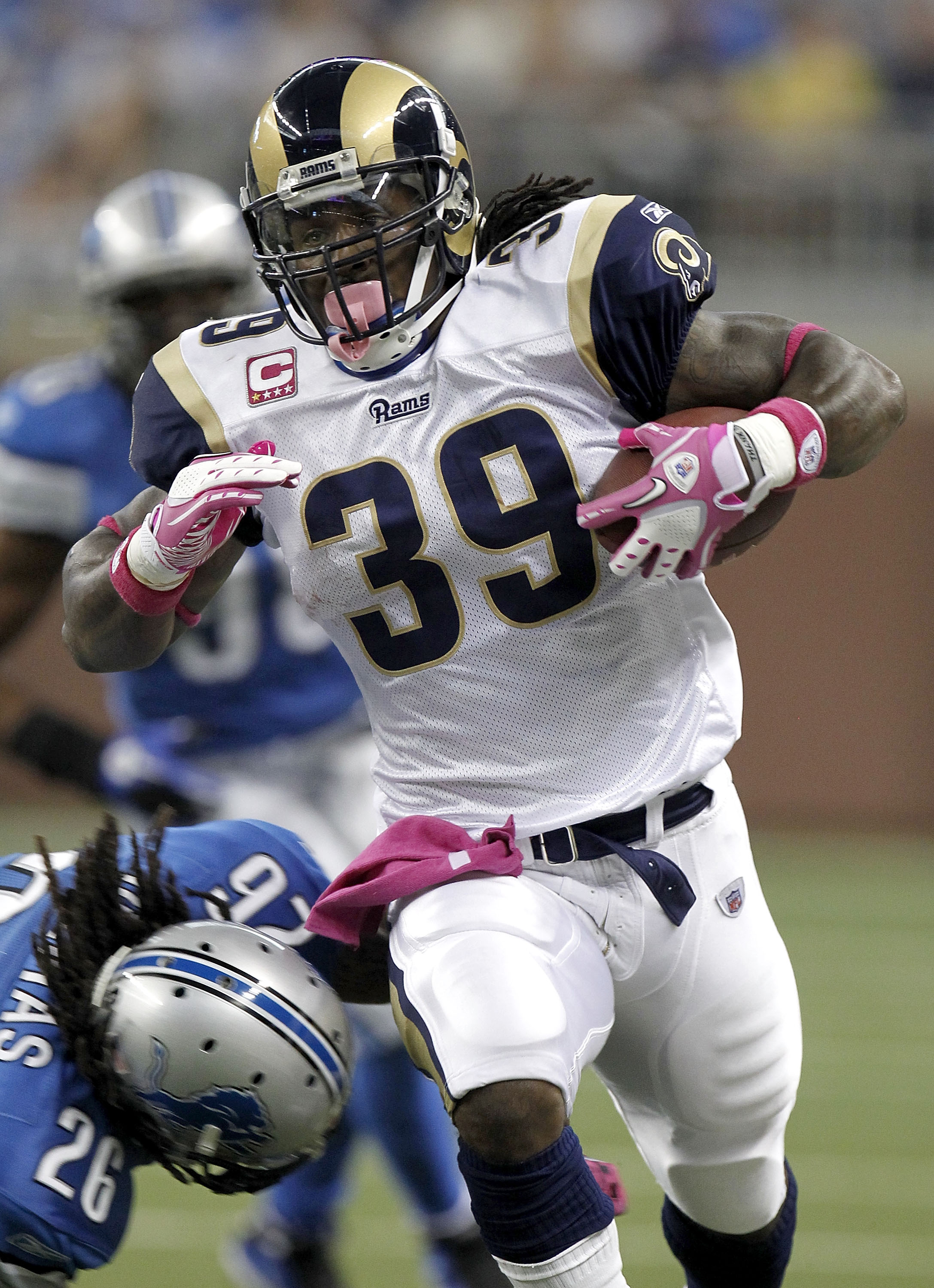 DETROIT - OCTOBER 10: Steven Jackson #39 of the St. Louis Rams tries to get around the tackle of Louis Delmas #26 of the Detroit Lions on October 10, 2010 at Ford Field in Detroit, Michigan. Detroit won the game 44-6. (Photo by Gregory Shamus/Getty Images