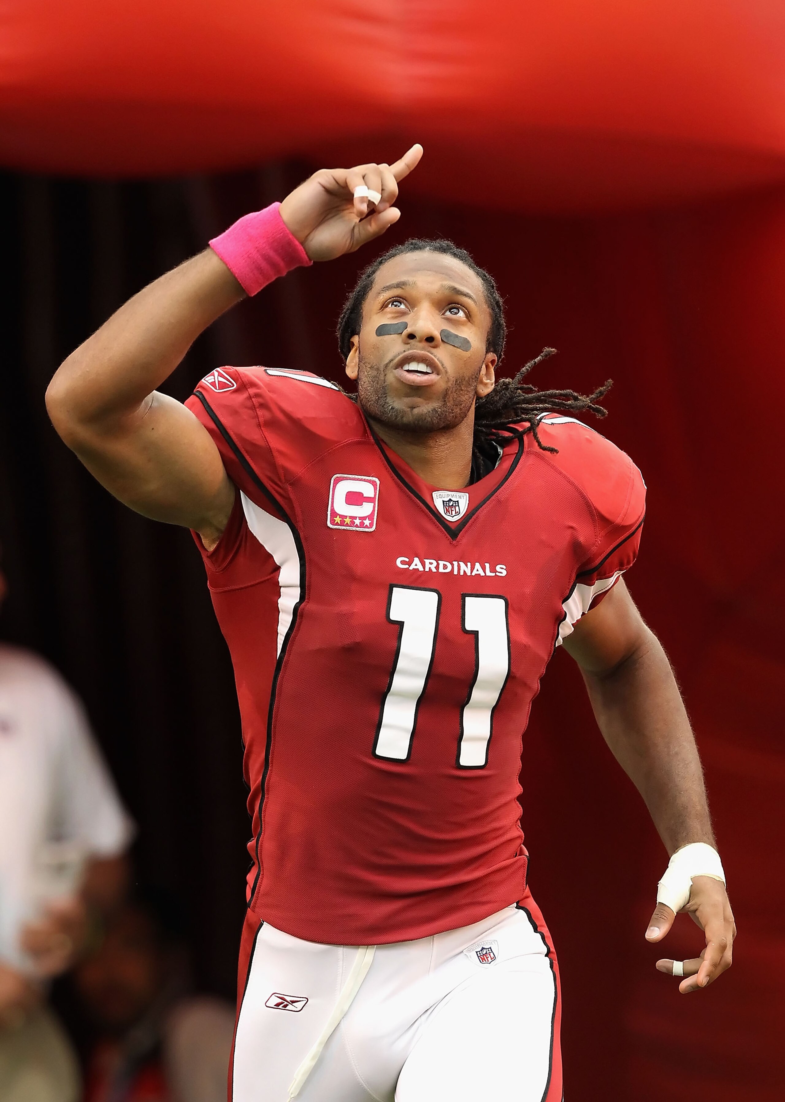 GLENDALE, AZ - OCTOBER 10: Wide receiver Larry Fitzgerald #11 of the Arizona Cardinals runs onto the field during introductions to the NFL game against the New Orleans Saints at the University of Phoenix Stadium on October 10, 2010 in Glendale, Arizona. GLENDALE, AZ - OCTOBER 10: Wide receiver Larry Fitzgerald #11 of the Arizona Cardinals runs onto the field during introductions to the NFL game against the New Orleans Saints at the University of Phoenix Stadium on October 10, 2010 in Glendale, Arizona.