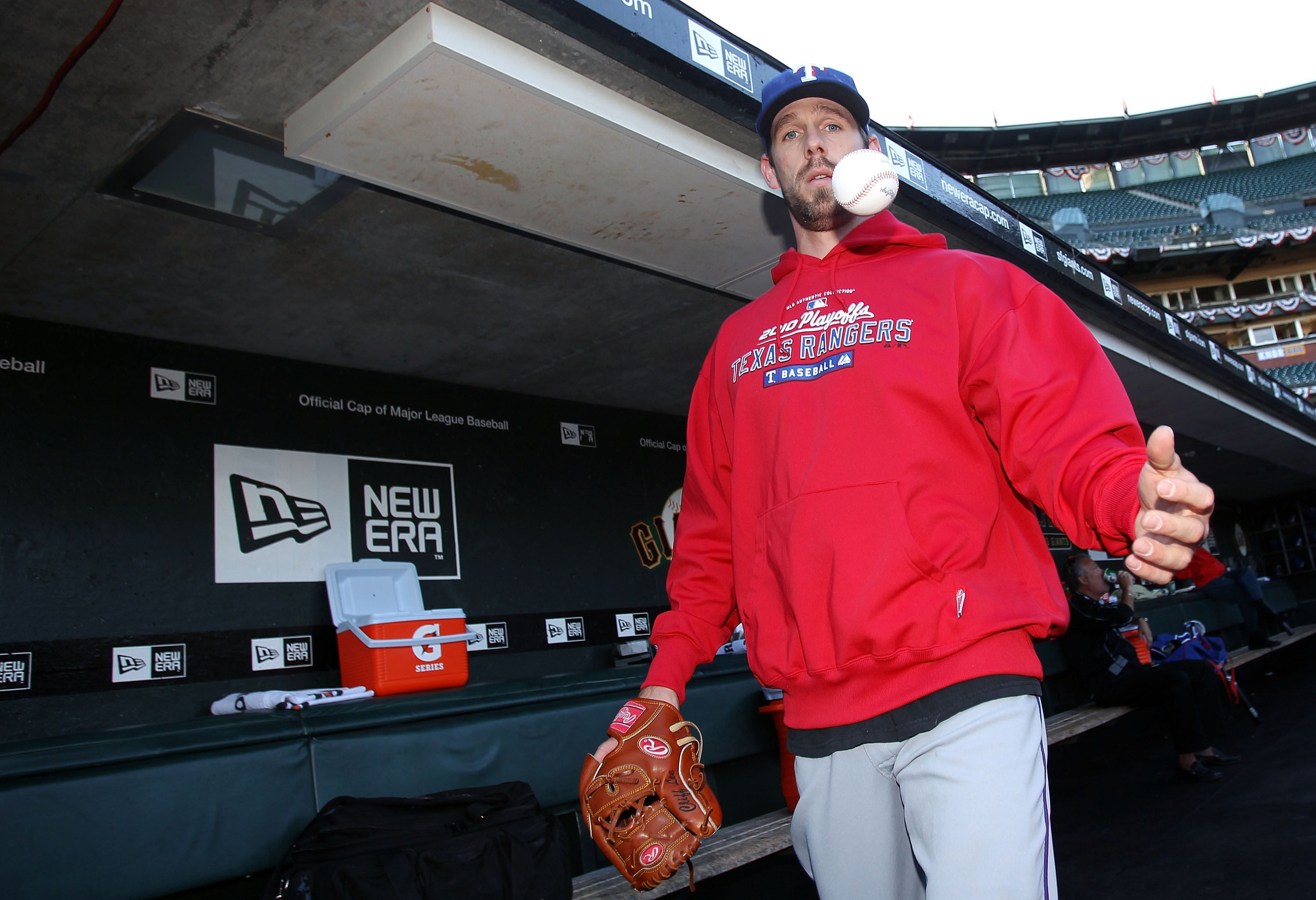 SAN FRANCISCO - OCTOBER 26:  Cliff Lee #33 of the Texas Rangers walks through the dugout tossing a baseball during a workout session at AT&T Park on October 26, 2010 in San Francisco, California. The Texas Rangers will face off against the San Francisco G