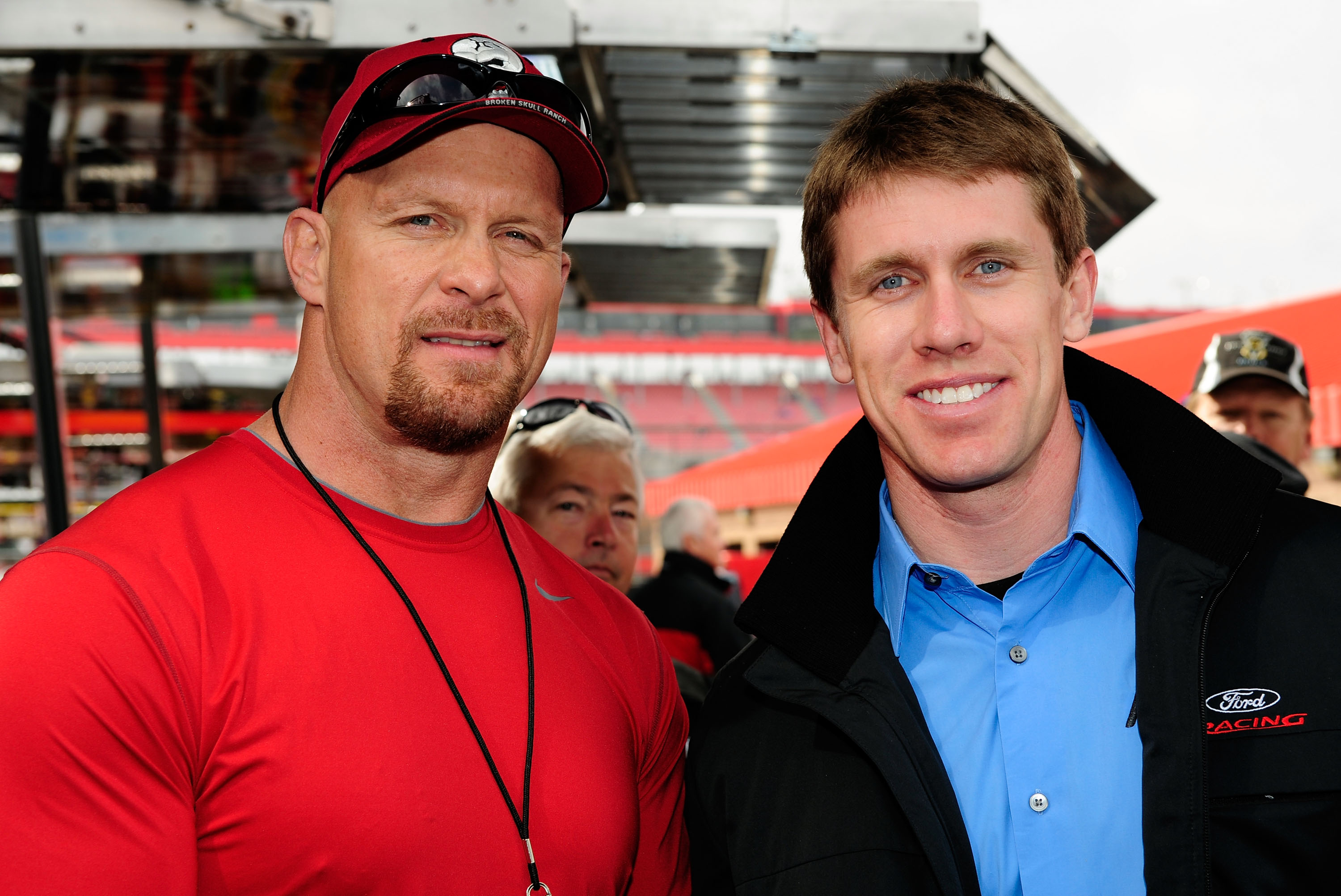 FONTANA, CA - FEBRUARY 21:  Actor Steve Austin and Carl Edwards, driver of the #99 Aflac Ford, pose for a photo in the garage area prior to the NASCAR Sprint Cup Series Auto Club 500 at Auto Club Speedway on February 21, 2010 in Fontana, California.  (Pho