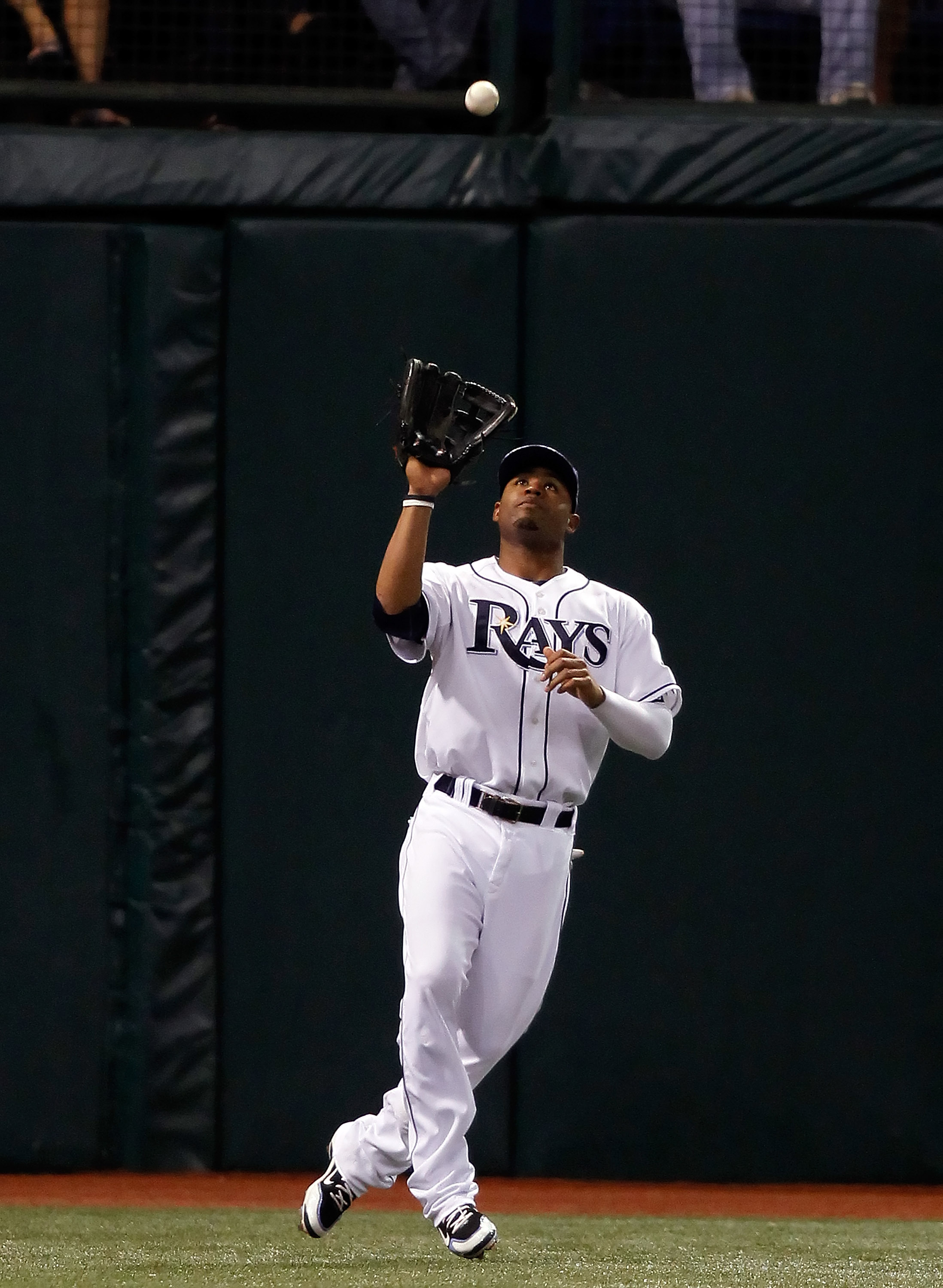 ST. PETERSBURG, FL - SEPTEMBER 29:  Outfielder Carl Crawford #13 of the Tampa Bay Rays catches a fly ball against the Baltimore Orioles during the game at Tropicana Field on September 29, 2010 in St. Petersburg, Florida.  (Photo by J. Meric/Getty Images)