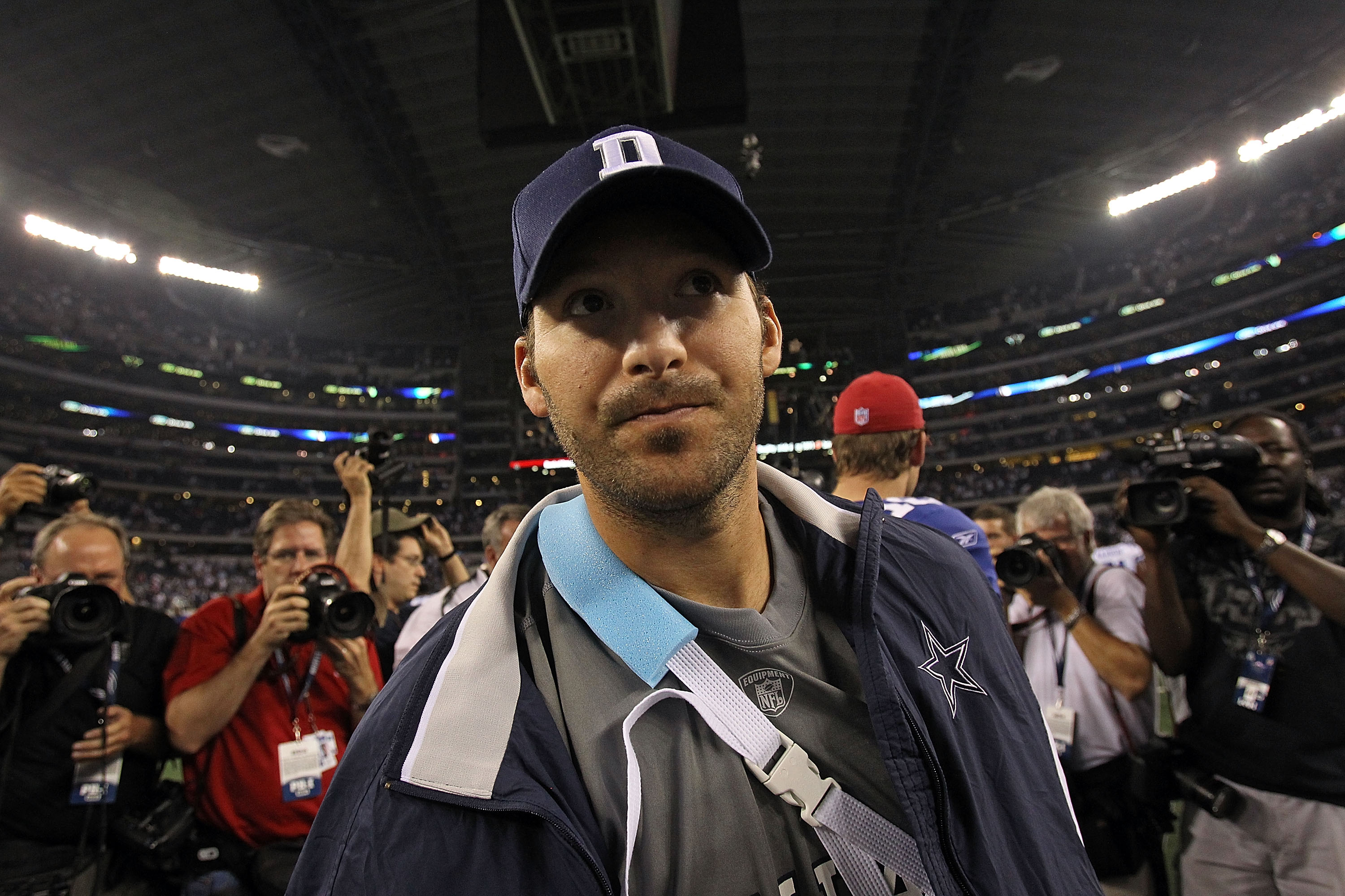 Dallas Cowboys Tony Romo walks off of the field holding his mouth piece  after New York Giants Jacquian Williams sacks him for an 8 yard loss in the  second quarter in week