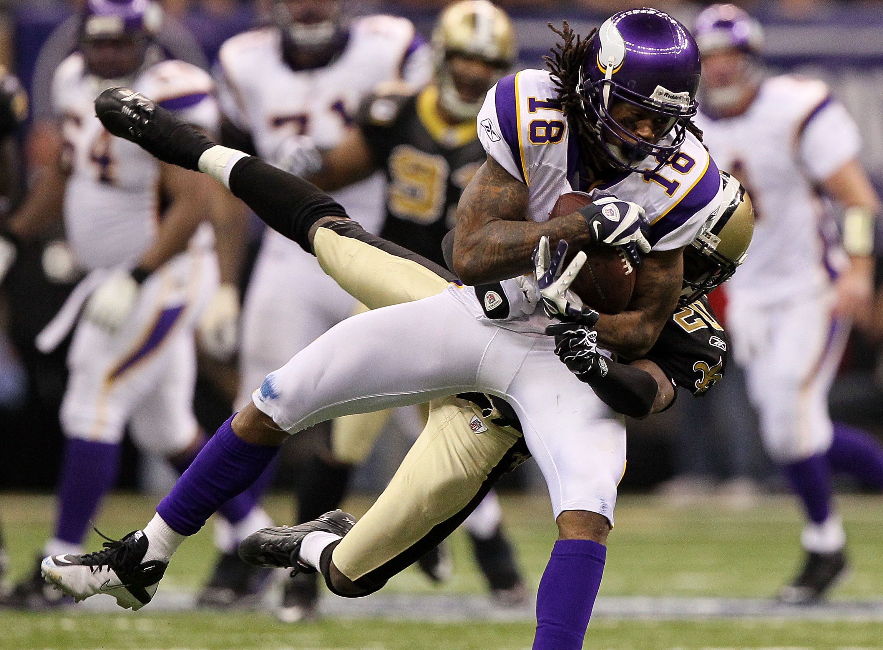 NEW ORLEANS - JANUARY 24:  Sidney Rice #18 of the Minnesota Vikings makes a reception against Randall Gay #20 of the New Orleans Saints during the NFC Championship Game at the Louisiana Superdome on January 24, 2010 in New Orleans, Louisiana. The Saints w