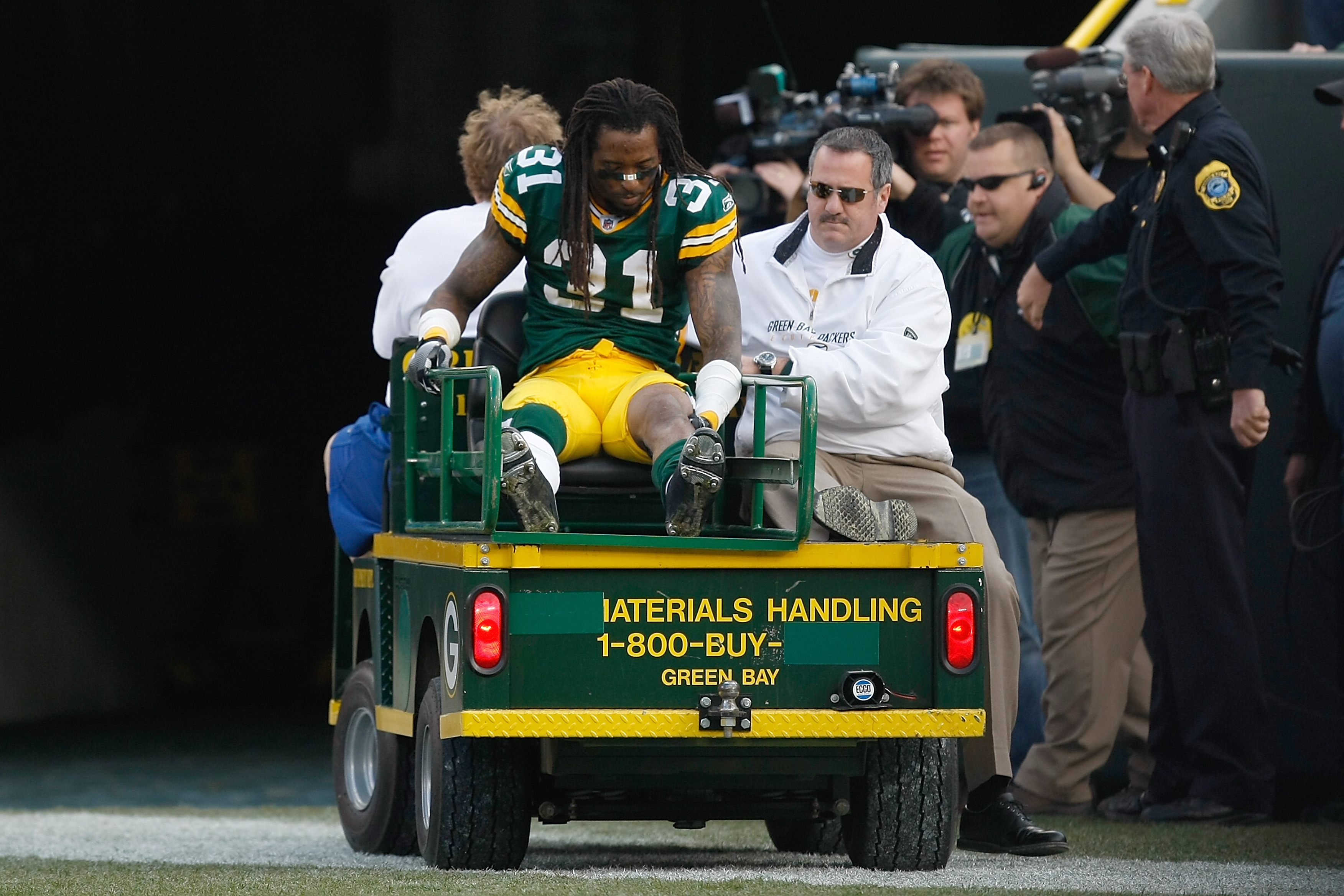 GREEN BAY, WI - NOVEMBER 22: Defensive back Al Harris #31 of the Green Bay Packers is taken off the field on a cart after an injury against the San Francisco 49ers at Lambeau Field on November 22, 2009 in Green Bay, Wisconsin. The Packers defeated the 49e