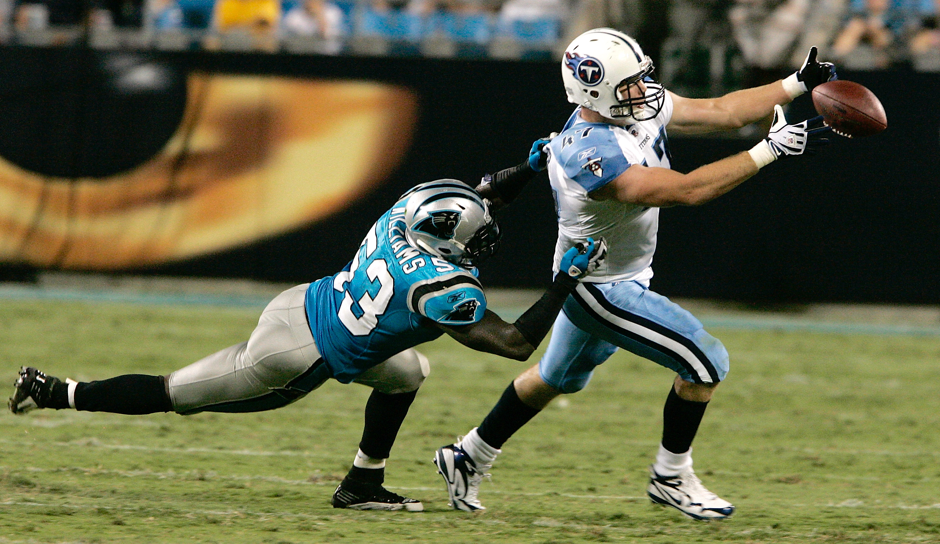 CHARLOTTE, NC - AUGUST 28: Wide receiver Damian Williams #17 of the Tennessee Titans drops the ball as Jamar Williams #53 of the Carolina Panthers drags him down during their preseason game at Bank of America Stadium on August 28, 2010 in Charlotte, North