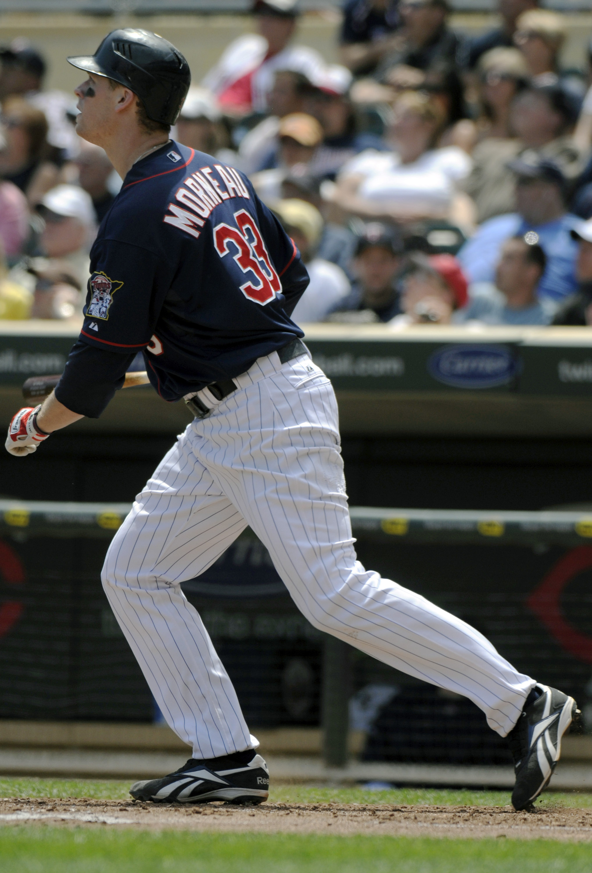 MINNEAPOLIS, MN - JUNE 30: Justin Morneau #33 of the Minnesota Twins watches the flight of his solo home run in the sixth inning against the Detroit Tigers during their game on June 30, 2010 at Target Field in Minneapolis, Minnesota. (Photo by Hannah Fosl