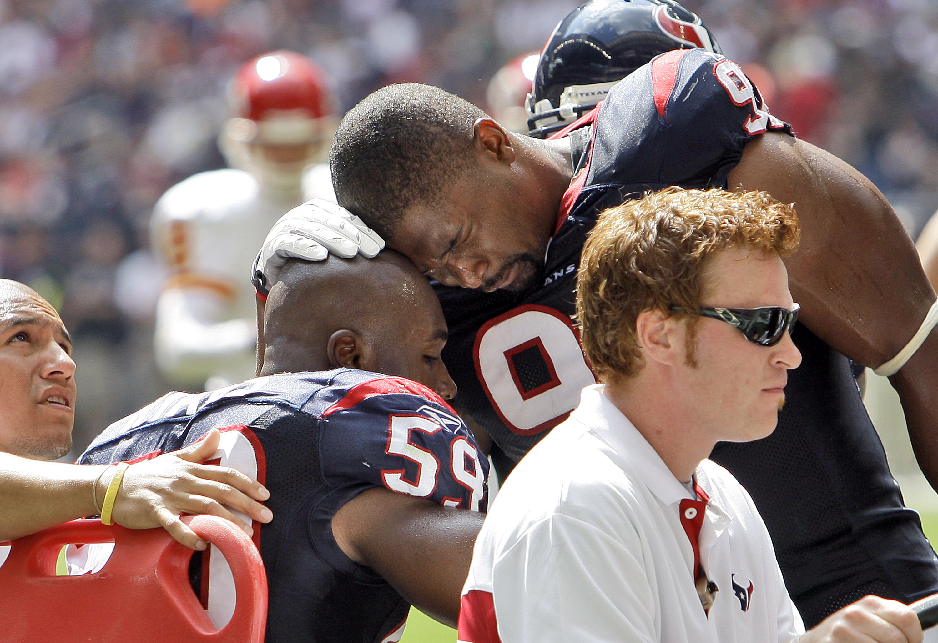 HOUSTON - OCTOBER 17:  DeMeco Ryans #59 of the Houston Texans is comforted by  Amobi Akoye #91 as he is carted off the field at Reliant Stadium on October 17, 2010 in Houston, Texas.  (Photo by Bob Levey/Getty Images)